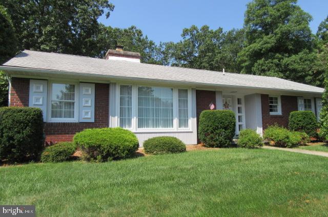 Sturdy older ranch home on level lot. This home is located just out of town in a quiet neighborhood at the end of the street. Plenty of off street parking in front of home for additional 4-5 cars. Large attached garage has two separate rooms for crafts or offices. Sit on the rear stone patio as you relax to birds singing. Large side screened porch is perfect for meetings,parties or just watching tv and relaxing. There are two bedrooms but a third bedroom can be made from the library. This house is true gem and won't last long.