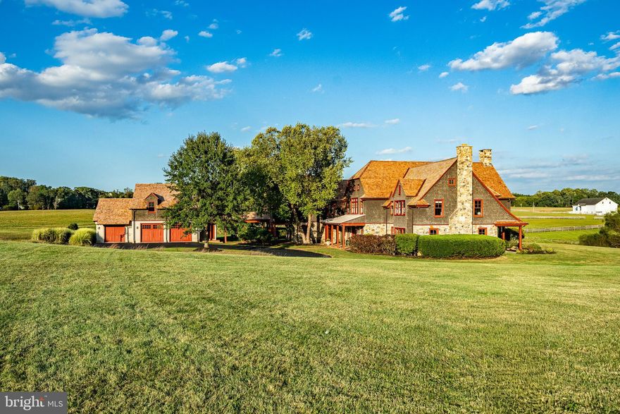 Eagle Hill is one of the most gorgeous properties on the market today. Designed by renowned architect John Milner and constructed by sought after custom builder Griffiths Construction, this 10,000-square-foot residence combines timeless craftsmanship with modern luxury. Set on a gated 15.29-acre parcel – once part of the historic 322-acre “Crebilly Farm” – the perfect siting of the home offers unparalleled privacy, breathtaking views, and direct access to 206 acres of conserved land with planned walking trails. 
From the moment you enter the home, soaring ceilings, reclaimed beams, antique wide-plank red oak floors, and hand-crafted millwork reflect superior quality and design. Expansive windows fill the interiors with natural light and frame panoramic vistas of the bucolic surroundings. Recent updates, including a new cedar shake roof, a number of new windows, newly refinished countertops and more, ensure the home is in turnkey condition. 
The floor plan is ideal for both everyday living and entertaining. The gourmet kitchen is a chef’s dream, featuring creamy custom cabinetry, limestone counters, a professional Viking double range with wall ovens, SubZero refrigeration, two dishwashers, and a large working island with multiple prep sinks. A bright breakfast room and adjoining great room with cathedral ceiling and tall Palladian windows create inviting gathering spaces. The dramatic soaring great room with a two-story stone fireplace flows seamlessly to terraces and a pool. Additional entertaining spaces include a formal dining area and a formal living room or den. This room can be closed off from the rest of the house with glass pocket doors and has doors leading out to a patio with gorgeous views over the stream and pastures beyond. Upstairs, the luxurious primary suite enjoys lofted ceilings, endless views, dual walk-in closets, and a spa-like marble bath with whirlpool tub. Four additional sun-filled bedrooms, two custom baths, and open lounge areas provide comfort and convenience for family and guests. A walk-up partially finished lower level with a large family room offers even more living and storage options. 
Additional highlights of the home include a spacious secondary prep kitchen, mudroom with full bath for access to the pool, a bar area for enhanced entertaining, a back staircase, a whole house generator, and an oversized three-car garage with a generous office or guest-suite with full bath above.  
Outside, the 15+ acres are graced not only with commanding views of the protected surroundings, but the tranquility of a babbling brook, the foundation of an old barn that has been converted into an idyllic secret garden, and a gorgeous inground pool. 
In Westtown Township and the highly ranked West Chester School District, Eagle Hill is ideally located just a short drive from downtown West Chester, near major commuting routes, top schools, dining, shopping, recreational amenities, and the Philadelphia International Airport. This one-of-a-kind landmark property combines refined elegance, modern functionality, all in an unrivaled setting.
