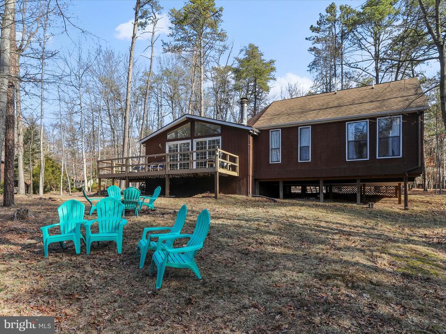 Welcome to Algonquin! This turnkey home is ready for you to capitalize on the short term rental experience or to make it your new home away from home! The gorgeous cabin in The Woods Resorts offers 3 main level bedrooms including a main level primary bedroom with an en suite and lots of natural light and a spacious upper level lofted bedroom/extra space--take time to appreciate the spiral stair case! Moving through the living room, you'll enter the open kitchen and dining area! Enjoy the views of nature from the double sliding glass doors or even on the back deck! The hardwood floors, tons of natural light and high ceiling in this space really bring the relaxing energy to the home! Off the kitchen are your two other bedrooms and additional full bath! This home offers an open backyard perfect for campfires and just taking in the surroundings and of course all the wonderful amenities of being in The Woods! Call today to talk about short term rental options and to schedule you showing! **Furniture is available for purchase as well