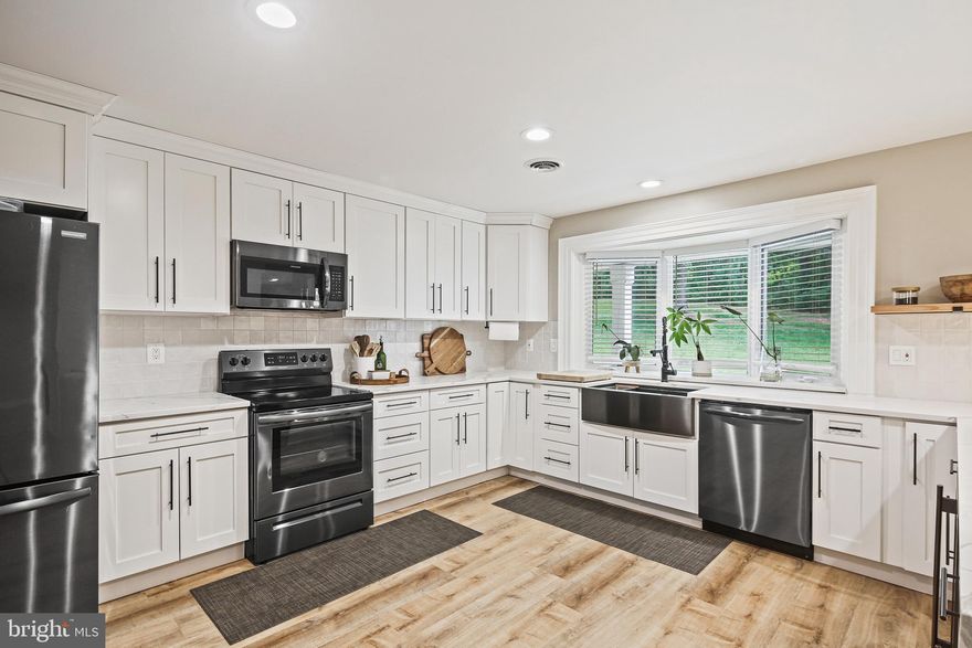 Welcome home to your stylish, contemporary, and secluded oasis in the heart of Windsor Mill!  This beautifully designed and spacious home boasts over 4600+ square feet of living space and is set on a picturesque 2.34-acre hillside with stunning views and unparalleled privacy.  Inside you’ll find 5 bedrooms, 5.5 bathrooms, a 2-car garage, in-ground pool, private deck and a 36x26 covered exterior porch (with a custom wood-burning fireplace) perfect for entertaining family and friend get-togethers.  The main floor has an open concept kitchen/dining/living room space filled with tons of natural light and a newly painted fireplace with a cast-iron wood burning insert and blower plus a new chimney liner.  The kitchen was remodeled in 2022 boasting white shaker cabinets, Frigidaire appliances, CalacattaLaza Quartz countertops, enlarged pantry and peninsula seating for four. There are 2 additional bedrooms on the main floor, each garnering their own en suite full bathroom along with added bonus room that can be used as an office/mudroom.  Upstairs features 3 freshly painted and generous sized bedrooms including the primary bedroom with a walk-in-closet and custom built office space between dormers.  The primary bathroom has a spa-like feel featuring a stand alone soaking tub, oversized glass encased shower and dual vanity.  Lower level has a fully finished basement featuring a secondary full kitchen space, fully customized gym, steam room (4 people) with ceramic tile, new electric fireplace, and a potential 6th bedroom with en suite bathroom.  New waterproof flooring and baseboards installed in 2024 and additional subpanel breaker installed (to support essential needs) and wired for generator use.

The exterior of the home comprises the feeling of a personal retreat starting with the newly resurfaced in-ground pool; new concrete, deck, pump, filters, plumbing, plastering and shed for pool house equipment.  The covered exterior porch has 2 ceiling fans, LED lights, a wood burning fireplace built with natural stone and a french drain installed surrounding the patio area.  Newly stamped concrete sidewalks at the front and back of the home along with new asphalt driveway and parking for 10+ cars.  The rear of the home features a newly built deck with Trex material.  Newly replaced roof in 2022 (GAF timberline shingles) and newly installed cedar shake style siding throughout the exterior of the home.  New front doors, sliding doors, gutters, soffits, and downspouts installed throughout the home.  New electric heat pumps (4 ton & 2 ton TRANE), 50 gallon hot water heater, and sump pump installed in 2022. New engineered hardwood and LVT flooring, ceiling fans, GFI outlets, switches, smoke detectors and added insulation throughout the entire home. 

This one-of-a-kind custom home features a fabulous floor plan and countless upgrades.  Conveniently located near amenities with easy access to shopping, restaurants, and major highways (I695 & I95) for commuting all while nested in the private confines of the outskirts of Baltimore County only 2 min from The Woodlands/Diamond Ridge Golf Courses.  This home offers a perfect blend of style, comfort, and convenience for a fulfilling lifestyle.  This one will not last long, schedule a showing today!!  **VA Loan Assumable at 6.25%**