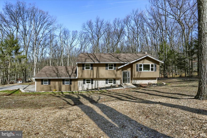 Take a second look at this lovely property!  Furniture was recently added to give the potential buyer an idea of how ideal this floor plan really is!  This  beautifully renovated home awaits in White Rock Acres, Cumberland Valley School District.   Open the door to find a very open floor plan!  From the VERY functional kitchen with a pantry, stainless steel appliances and an island that has a wood block counter top-perfect for cooking/baking/entertaining!  The access to the 16x16 deck is off the kitchen-the views of the backyard are spectacular-offering approximately a half acre of land in the back! From the deck you also have stairs to take you down to the fenced yard and lower level of the home-so convenient!  Go through the gates to access the the  outdoor shed for storage or to host additional equipment you may have.  A concrete patio with fireplace for making smores or just to cozy up for those chilly late winter/early spring nights, while looking at the stars in the back yard!   Let's go back inside to finish the tour of the upstairs-LOTS of storage, 2 full baths and an owners suite that has a gorgeous walk-in closet with organization system and window for great fresh air.  Heading to the main level you will find another open floor plan with a great room offering a wood burning fireplace complete with new liner and chimney cap, LOTS of storage and a mudroom that you can utilize for whatever you need!  Another full bath hosting the laundry-such ease if you have been working outside to come in and just clean up, you don't need to mess up the rest of the home!  You will find another LARGE bedroom or if you prefer craft room, play room, let your imagination decide.  The mudroom allows entry to the oversized 2 car garage complete with a pull down for attic storage.  There is a man door to go out to the back yard from the garage.  Want to live in the woods with the conveniences of public water/public sewer-this may be the home for you!
