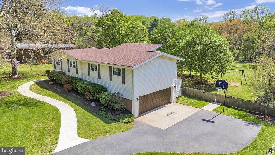 ***PUBLIC OPEN HOUSE, SUNDAY, APRIL 17TH, 11:30AM TO 2:30PM --- Expansive, 3600+SF, split-level colonial on idyllic flat 1.87 acre lot backing to trees/parkland! No HOA!  This gorgeous updated home boasts an entertainer's floorplan with its dramatic open living/dining/family room, updated kitchen with cherry cabinets and stainless steel appliances with an inviting breakfast area overlooking the great room, gleaming wood floors, vaulted wood ceilings, hall full bath, 5 bedrooms; including a generous owners suite with a wall of windows/transoms, new designer primary bath with double vanity, freestanding soaking tub and shower room, walk-in closets, and two private office/dens for in-home office and/or exercise room! The lower level boasts a sunny rec room with sliding door to the oversized terrace, full bath, separate laundry room, mudroom/hall with metal lockers that convey, leading to the oversized garage with room for 2 cars, storage and a workshop area, plus a large bonus room. Additional improvements include an expanded asphalt driveway, stamped concrete front walkway, fully fenced rear yard, brand new furnace and AC unit April 2026 with 5-year transferrable warranty, New Garage door April 2026, 2022 Hot Tub on back terrace conveys with cover and equipment, 6 year old Hot Water Heater, 6 year old roof/gutters.  Septic and water treatment systems are regularly serviced and in good condition.  GREAT LOCATION:  Clarksburg High School District, and 7 minutes drive to Wegmans/Milestone shopping/dining, I-270, and close to Butlers Orchard and county parks & recreation.