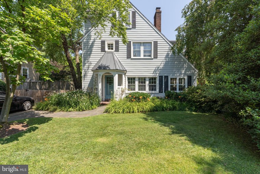 Charming updated and expanded home in coveted Battery Park!  Expansive beautifully landscaped 11,416 s.f. lot.  Classic cottage with original hardwood floors, updated kitchen with marble counters, formal dining room, living room with wood-burning fireplace and stunning family addition with soaring ceilings and custom built-ins. This lovely home has been updated and beautifully maintained by its longtime owner.   The wonderful circular floor plan is excellent for entertaining family and friends.  Relax with your morning coffee or your evening glass of wine in the solarium.  On the second level you will find three bedrooms and 2 updated bathrooms with gleaming hardwood floors and abundant light.  The top floor offers another bedroom with an ensuite bathroom.  The basement offers a full bathroom and an additional playroom/gym/flex space.  The yard is perfect for play and relaxation.  There is a detached garage (no longer accessed with a driveway) which would be perfect to create a home office or art studio or for additional storage. And all of this is conveniently located to Metro, retail and restaurants.