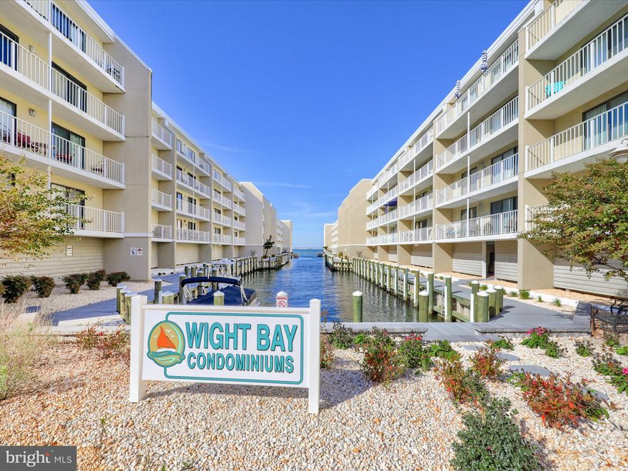Bay side beach living awaits! Canal front two bedroom, two bath getaway in desirable Wight Bay condominium has great amenities & convenient midtown location. Walk to the beach (or Seacrets world-famous experience right next door) or enjoy time at the pool overlooking the bay. Spacious balcony with access from the living area or bedroom invites easy relaxing with a view of the canal and bay. Boat and jet ski slips available to residents, and a newly upgraded community boardwalk along the bay is perfect for watching amazing sunsets over the Assawoman Bay. 
Property is turn-key and being sold with all furniture included. While not currently a rental unit, it would make an excellent rental investment opportunity. Upcoming assessments for stairwells to be paid by sellers; $2,500 due in February 2024 and $2,500 due in June 2024. Make your appointment to see this coastal gem today!