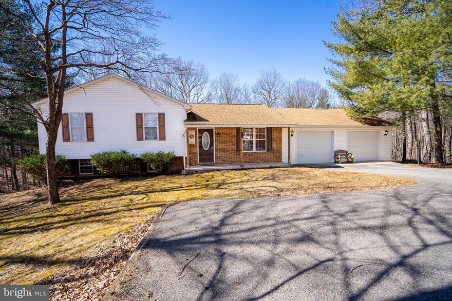 This adorable split-level home on 1.19 Acre features 3 bedrooms and 2.5 baths. Recent updates include LVP Flooring, Trane HVAC system. Spacious kitchen open to Sun Room, Dining and front Living Room. Large primary bedroom has updated full bathroom with stall shower. Hallway full bathroom with tub surround has sky light to brighten up the space. The lower level of the home has finished rec room, laundry room and half bath. French doors walk out to private back yard. Large lot offers ample space for gardens, play areas, firepit if desired. Two Car attached garage 2 overhead doors with openers, plus has electrical outlets and room for work benches, storage cabinets/shelving. Conveniently located south of Berkeley Springs, with nearby Cacapon State Park and the VA Line for commuters. Just minutes to shopping, restaurants, medical and lodging.