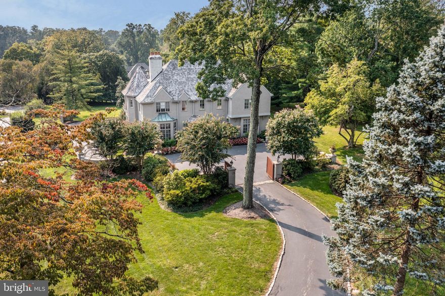 Welcome to 760 Mount Pleasant, a beautiful 5 Bedroom, 6.5 Bath estate located on the prestigious Main Line, with the front of the home being built in 1992 and the back in the 1800's. Offering almost 8,000 square feet of impeccably maintained living space; the gated entrance and winding drive set the tone for this charming manor with traditional elegance throughout. Step through the double doors into the grand foyer with handsome floors that continue all through the main level. A traditional study features paneled walls with wood detail, crown molding, built-ins, and a gas fireplace w/ marble surround & intricate wood mantle. The formal Living Room features crown molding and wood-burning fireplace w/ wood mantle, as well as doors leading to the stone patio. Just off the upper level of the grand foyer, the formal Dining Room, with crown molding and outside access to the same patio creates a perfectly sophisticated entertainment space. The updated eat-in Kitchen boasts white cabinetry w/ thoughtful details, high-end appliances & countertops, elegant tile backsplash, center island w/ seating, and a bright breakfast room w/ access to the back patio, making this a great space for both, casual meals with family & friends, and dining al fresco in the warmer months. An oversized Family Room with a cozy loft, beamed ceilings, wet bar, full bathroom, gas fireplace, & outside access offers the ideal place to gather and entertain. A Half Bath completes the first level. Head up the grand staircase to the Primary Bedroom ensuite featuring a sitting area w/ Juliet balcony, gas fireplace, custom closets, and a Full Bath with three vanities, soaking tub, separate glass shower & water closet. 3 additional Bedrooms and 2 Full ensuite Baths and a Full Hall Bath complete this level. Head up another set of stairs to find the 5th Bedroom ensuite with two sitting areas offering a private, flexible space. The Finished Basement provides additional living space w/ full bathroom, laundry room, utilities, & Kohler full-house generator. The back yard offers a serene setting to both start and end your days. Perfectly situated in the highly ranked Lower Merion school district, and just minutes from local shopping & dining as well as major highways and public transportation, you won’t want to miss out on this truly remarkable home.