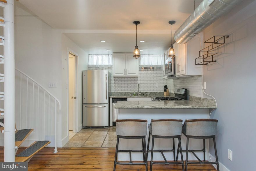 Don't miss out on an opportunity to live in this Washington Square West home. Walk through the charming community's gated courtyard down into your own private sun-drenched patio. Enter your main floor with original wide-plank pine floors throughout. The open concept living area is an entertainers' dream with lots of natural light, exposed brick and ductwork for that loft feel. Continue through to your kitchen complete with granite countertops, white cabinets and stainless steel appliances. A powder room completes the first floor. Take your extra-wide spiral stairs up to your lofted, open master suite with an exposed brick fireplace, a laundry closet, and a huge walk-in closet. Your spa like bathroom comes with jacuzzi tub, stand alone shower and sink. The patio is perfect for extra entertaining space and cozy dinners. Located across the street from Seger Park and near Whole Foods. Great restaurants, entertainment and everything else the city has to offer are an easy walk in any direction including Washington Square West, Bella Vista, Broad Street and and South Street.