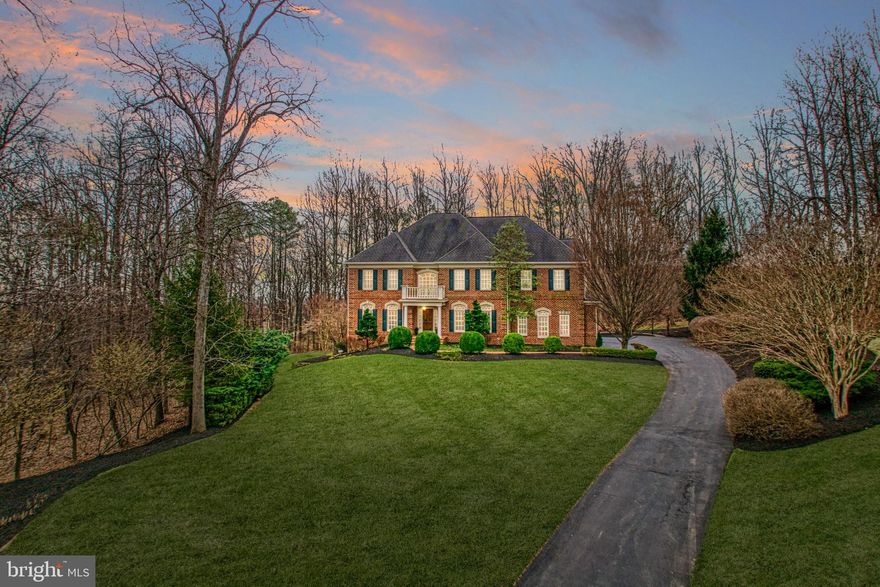 Picturesque with handsome four-sided brick facade and nearly four acres of lush, wooded privacy, this thoughtfully constructed Renaissance Grand Rembrandt is a 7,429 square foot beauty within sought-after Beacon Hill. Inviting from the foyer with graceful sweeping staircase, beautiful hardwood floors, and crisp hues, this home welcomes with vistas for gathering, entertaining, and work dotted by superbly constructed built-in storage, French doors, housewarming fireplaces, and elegant fixtures. In the expansive gourmet kitchen, high-end appliances, butler’s pantry, and walnut-hued cabinetry assist with memorable meals, while a granite-topped island is perfect for planning recipes and rolling-out dough. Serve guests within the breakfast nook and formal dining room or choose to take a glass of wine to the screened outdoor living area, where a brick-wrapped fireplace adds atmosphere and warmth. Inspire memorable moments while grilling summer skewers and strolling under this property’s seasonal foliage. Inside, holidays and weeknights at home are cared for by the living room’s double-storied stone hearth and built-in entertainment center. Within the lower level, casual living includes room for billiards, gym, and an unfinished space where you’ll stow away collections or construct the creative space of your dreams. Five bedrooms, each with en suite baths, care for the day’s end. Recover in the primary suite’s sitting room, with soothing peninsula fireplace, and recover after long afternoons with the help of dual vanities and a view-filled place for bubbles. Beautifully maintained by the home’s original owners, ask about the home’s recently refreshed finishes, and visit the three-car garage, which provides ample vehicle storage and is perfect for weekend projects. From home, stroll Beacon Hill’s walking trails, and enjoy proximity to Routes 7 and 9 where commuting destinations, historic townships, entertainment, scenic vineyards, and greater Loudoun County awaits.