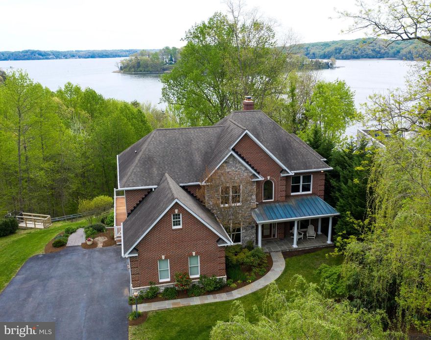 Enjoy gorgeous sunrise views overlooking Little Round Bay and St. Helena s Island, from this turn-key 5,688 sqft custom waterfront, situated in very private setting.  With nearly $100k in recent improvements the home feels like it s brand new featuring a travertine tile entry, refinished Brazilian cherry floors, a two-story family room with a stone hearth, wood-burning fireplace and a built-in entertainment center.  The main level also features a beautiful home office and an optional bedroom/second office and a full bath.  The gourmet kitchen boasts brand new marble countertops, Viking fridge, Kitchen Aid dishwasher & warming drawer, Best by Broan cooktop & oven and an island with a prep sink.  A butler pantry with wine storage and under-cabinet beverage fridge is centered between kitchen and dining room.  Upstairs, the master suite features a tray ceiling, cozy coffee deck, large walk-in closet, a luxurious bath with travertine marble countertops & floors, a double-headed tile shower, two vanities and a soaking, Jacuzzi tub.  The three additional bedrooms on the upper level share a tri-entry bath with two new separate vanities. Upstairs landing includes built-in bookcase with area for seating to create an open library with water views. The laundry room with washer/dryer is also on the upper lever.  The lower level offers a rec room, family room with a stone hearth fireplace, an antique wood Belgian bar, tin ceiling reclaimed from the Kennedy Theatre in Washington, DC, a 5th/6th bedroom with stone fireplace & full bath (including 'Steamist' steam shower), a craft room, and boat storage room.  The Beam central vacuum system services the entire house, including a hands free dust pan built into the kitchen island, and the Water Furnace geo-thermal system provides efficient heating and cooling. Venture out onto the Epe deck and soak in the Hot Spring Jacuzzi while enjoying your favorite music on the Bose outdoor speakers.  Or take the Marine Innovation tram down to the private deep water pier with one Magnum boat lift and a personal watercraft lift.  Enjoy crabbing and fishing off of the pier and fires on the shore. Conveniently located just 9 miles to downtown Annapolis and close to I97 and Route 50.  By water it s ideally located for quick access to Smith's Marina and fuel dock, Annapolis and the Chesapeake Bay, and by land to the Herald Harbor grocery and package store, the Herald Harbor Hide-away bar and restaurant, and access to the Herald Harbor Arden hiking/mountain biking trail system.  The neighborhood even has it s own fire department, church, playground and community center. Once a peach farm,   Herald Harbor is more than just an address-it's a community.  Beyond the welcoming neighbors, there are plenty of things that make Herald Harbor a special place to live.  Once considered a part-time community, Herald Harbor has grown to a thriving and involved full-time, year-round neighborhood.  Watch the VIDEO VIRTUAL TOUR here: (insert site when available) For community information and it s history please visit: https://www.heraldharborcommunity.com/history