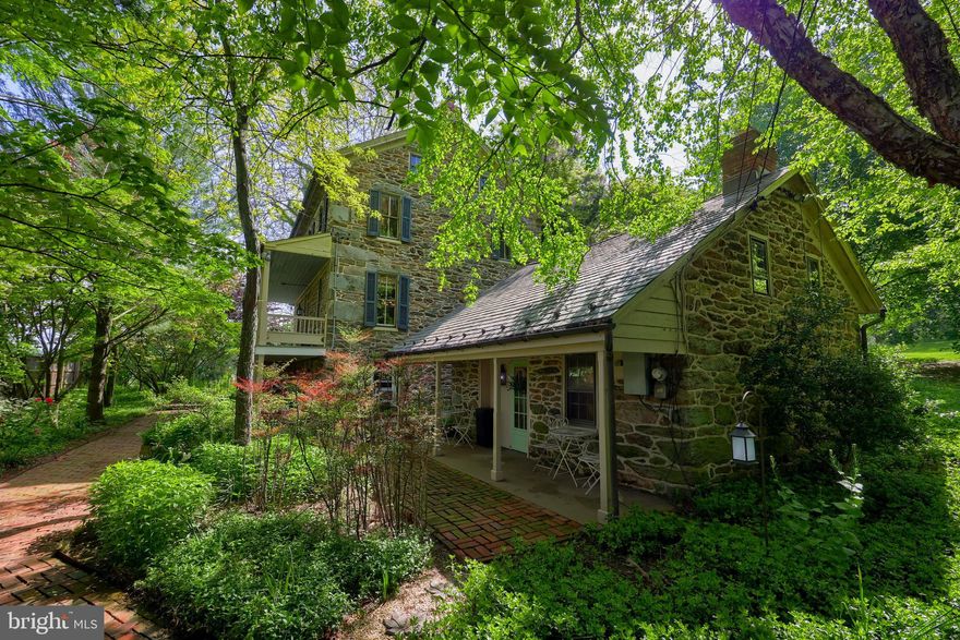 10 lush private acres offers a stone farmhouse circa 1800's with a summer cottage, 3200 sqft bank barn that has been restored by Amish builders, a 6 bay - two story garage, log bake oven, covered bridge, extensive hardscaping, and mature landscaping. Currently being used as a wedding venue - approved for event center & country inn to include overnight stays. The entry level is highlighted by gorgeous hardwood flooring, brick accent walls, wood stove, and half bath. Currently being utilized as a groom's suite. The upper level can be used as a joint gathering area with a full kitchen, living area, and half bath. The kitchen is fully equipped with stainless steel appliances, center island, pantry, and dining area. Directly off of the kitchen is access to the balcony where you can enjoy the wonderful views of the countryside. Three bedrooms, two full baths, half bath, and den area with built-ins complete the 2nd level. The third level has been finished with wide plank hardwood flooring and skylights. Perfect for an additional bedroom or bonus space. The charming summer cottage is equipped with a full kitchen, full bath, living area, and upper level bedroom. The bank barn can accommodate up to 120 guests and is highlighted by a silo, turned bar, for cocktail hour. Included in the sale is an entire in-house inventory of wedding decor that can be stored in the lower level of the bank barn. If you are looking to start your own business - this is your opportunity. Everything you need to get started is available right here! History of Wisteria Cottage and Barn: Historic Kroh Farm which was originally part of the Kroh Paper Mill. A log smokehouse sits on the property and dates back to 1820 and is one of the few surviving original smokehouses left standing in Carroll County. The main home was built in 1880 for two families and original woodworking pieces were uncovered and restored to use amongst the property renovation. This unique property was recognized for its historic charm and featured on the Maryland House and Garden Pilgrimage Tour in 1995.