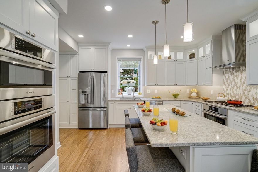 The Sound of convenience comes with luxury finishes & prime location with stunning pricing…where else will you find a spacious 6-bedroom, 3.5 bathroom, 3-level, 2 car attached garage newly renovated home in North Arlington for under $1,500,000?
6869 Washington Blvd is an easy walk to the East Falls Church Metro swiftly delivers you to Dulles International, Reagan National Airport, Pentagon, or D.C. while you enjoy your favorite author or catch up on your emails.  The direct access to I-66 is unparalleled! Around the bend the Fall Church City Farmer’s Market will delight your senses. Dash along Langston Blvd to treat your tastebuds at Heidelberg  Bakery or follow Washington Blvd to The Italian Store. 
This home inviting renovations entice the senses from freshly painted throughout, 2-levels of hardwood floors, 3-gas fireplaces, Anderson windows & sliding glass door, open concept floor plan, Carrara marble showers, heated floors, walk-in closets, custom solar light tubes, soaking tub, 2-laundry rooms, front loading washers & dryers, finished lower-level, lower level walk-up, professionally landscaped, architectural shingle roof, garage with fresh epoxied floor, steel beam with hoist system and overhead garage storage. The freshly refinished hardwood floors throughout the main level flow majestically to the inviting living room for a warm guest greeting, turn to the dining room and serve a glass of wine before stepping into your custom kitchen by award winning designer, Allie Mann of Case Design; enjoy quartz countertops, 2 convection wall ovens, built-in microwave, Crystal Cabinets with child locks, undermount lighting, French door refrigerator, stainless steel appliances, kitchen water reverse osmosis dispenser, recessed lighting, gas range with tile to ceiling custom backsplash showcasing vented hood, lighted transom display cabinets, bump out window for herbs & flowers over the double sink, eat-in breakfast nook overseeing the lush professionally landscaped yard, built-in pantry with pull out shelves, island with pendant lighting, storage & enticing seating as the aroma from a great Italian sauce fills the air! The family room shines with the gas fireplace & sliding glass door to a two-level entertainer’s deck. Main level powder room shines with midnight blue vanity, Carrara marble counter & travertine flooring. Gliding up the refinished hardwood stairs inspires tranquility with 4 bedrooms featuring new hardwoods. Primary suite with whispers of romance of the glowing built-in gas fireplace, 2-walk-in closets, new en-suite with Carrara marble rain shower with wand, niches plus thoughtful foot niche, soaking tub with wand, dual marble vanity, cabinet mirror with anti-fog & dimming light, heated granite floors & water closet. Bedroom level laundry area offers abundant cabinet, granite counter space, soaking sink & raised front loading washer & dryer. Hall bath Carrara marble shower, 2-niches, dual vanity, granite counters & linen closets. Lower-level bonus den fireplace is a fantastic gathering space to play board games, cards, and share life adventures. Two bedrooms, one with a grand walk-in closet and both enjoying their private entrances to the shared en-suite. Laundry area & walk-up yard access round out the excellent convenience of the lower level. 6869 Washington Blvd delivers ease of access to East Falls Church Metro, I-66, I-495, D.C., Pentagon, Falls Church City, Reagan National Airport, Dulles Airport, Westover, Arlington Blvd, Rte. 50, farmers markets, parks, trails, shops & restaurants.