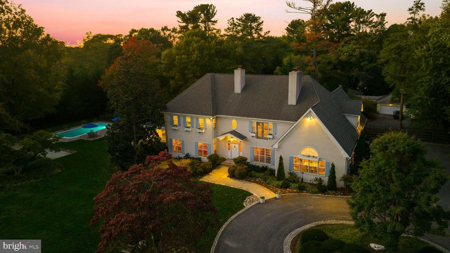 Live authentically. A rare find on a double lot in Baltimore County. Privacy abounds. As the gate pulls back, encircled by lush grounds, a graceful sense of arrival unfolds along the circular drive. Beyond, leisure awaits... challenge your aim on the chipping green, share laughter over bocce, or unwind beneath the stars in the inviting hot tub and take a dip in the moonlight. Designed by Robert B. Patton. Gracious interiors welcome you! Bright, expansive spaces and walls of windows make for a comfortable, happy lifestyle. Flow seamlessly between dining, billiards and a statement kitchen that evokes the countryside in France with fireplace, cathedral ceiling, and beams. Five working fireplaces in total. Come home for the holidays! Enchanted primary suite with indulgent bath and dedicated light filled dressing room. Getting ready for the day is more joyful than ever. Fabulous secondary suites. Outdoor porches beckon your presence. Incredible access to everywhere you want to be. Feel worlds away. Xfinity Internet. Cultivate your existence. The art of uniting human and home.