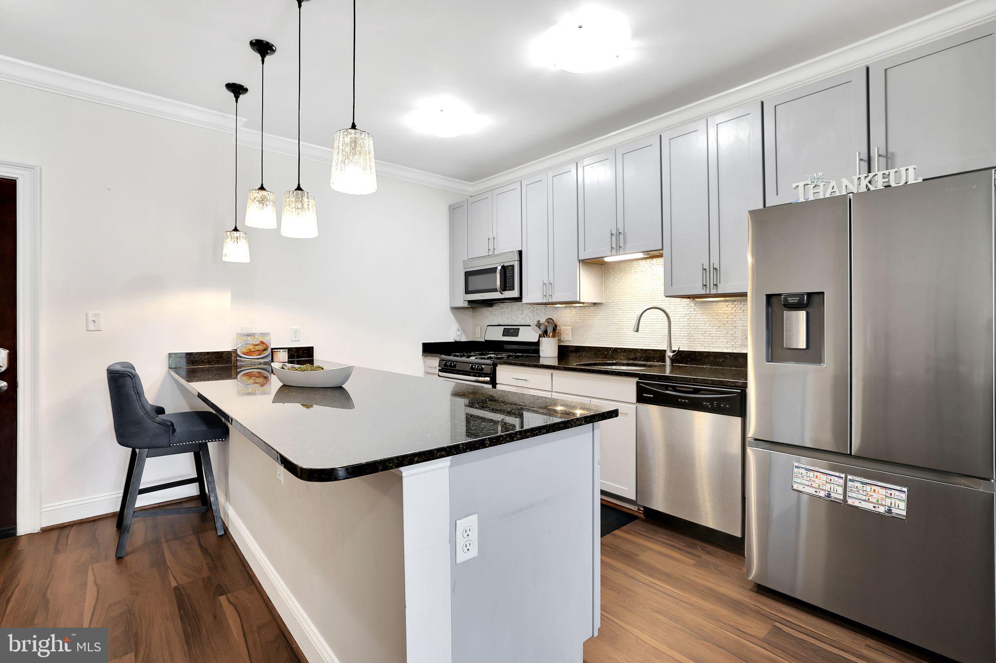 Exceptional 1-Bedroom + Office Condo at The Isabella at Monticello Mews
Discover this stunning main-level residence featuring a spacious 1-bedroom, a versatile office space, and a full bathroom, all within the desirable community of The Isabella at Monticello Mews. This style unit offers a private patio entrance, soaring ceilings, and 867 square feet of thoughtfully designed living space—one of the largest one-bedroom layouts in the building.
The open floor plan is illuminated by abundant natural light and enhanced by brand-new recessed lighting fixtures, creating a warm and inviting atmosphere. The home also features a newly installed water heater, ensuring peace of mind and energy efficiency. The well-appointed kitchen boasts wooden cabinetry, gleaming granite countertops, a breakfast bar with pendant lighting, and stainless steel appliances—perfect for everyday living and entertaining.
Relax in the spacious living and dining area, which opens through a sliding door to a private patio, ideal for outdoor lounging and sunset views. The generous bedroom features LVT flooring, ample closet space, and easy access to a full bathroom with a granite vanity, tiled tub/shower combo, and additional storage. Convenience is further enhanced with a full-sized in-unit washer and dryer, mirrored closet doors, and a Nest Thermostat controllable remotely.
This pet-friendly, gated community offers a wealth of amenities including a pool, dog park, tennis and basketball courts, a fitness center, a community room, and a shuttle service to Van Dorn Metro. Located across from Bren Mar Community, residents enjoy access to an additional lap pool, tot lot, and outdoor recreation facilities.
Commuters will appreciate the easy access to I-495, I-395, and S Van Dorn Street, along with proximity to Safeway, Dunkin’, Starbucks, and various dining options. This exceptional condo also includes one garage parking spot, guest parking, and extra storage space.
Don’t miss this opportunity to enjoy comfortable, modern, and convenient living—schedule your visit today!