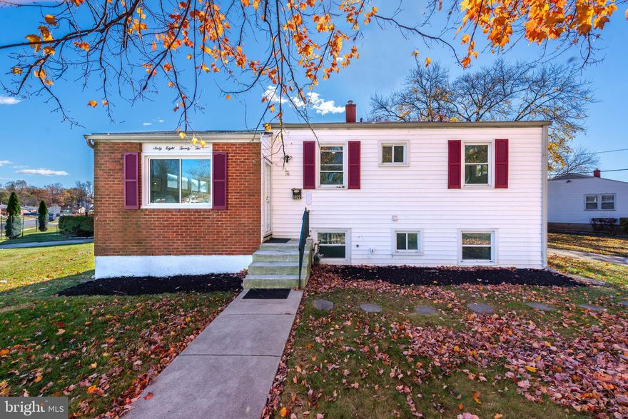 Beautifully renovated split-level home situated on a spacious corner lot, offering a bright open layout and modern updates throughout. The main level features an inviting open floor plan with abundant natural light, wood flooring, and a seamless flow between the living room, dining area, and kitchen. The gourmet island kitchen is designed for both functionality and style, complete with Quartz countertops, stainless steel appliances, ample cabinetry, and a large center island that provides additional prep space.  The upper level includes three well-sized bedrooms and a remodeled full bath with contemporary finishes. The fully finished lower level provides valuable additional living space, featuring a generous family room suitable for a variety of uses, a 4th bedroom, a second full bath, and a large laundry and storage room for added convenience.  Outdoor living is enhanced by a rear deck overlooking a wide, open backyard, offering plenty of space for recreation, gardening, or future outdoor projects. A storage shed and an extended driveway with multiple parking spaces complete the property. Renovated with comfort and practical living in mind, this home is move-in ready and thoughtfully updated.