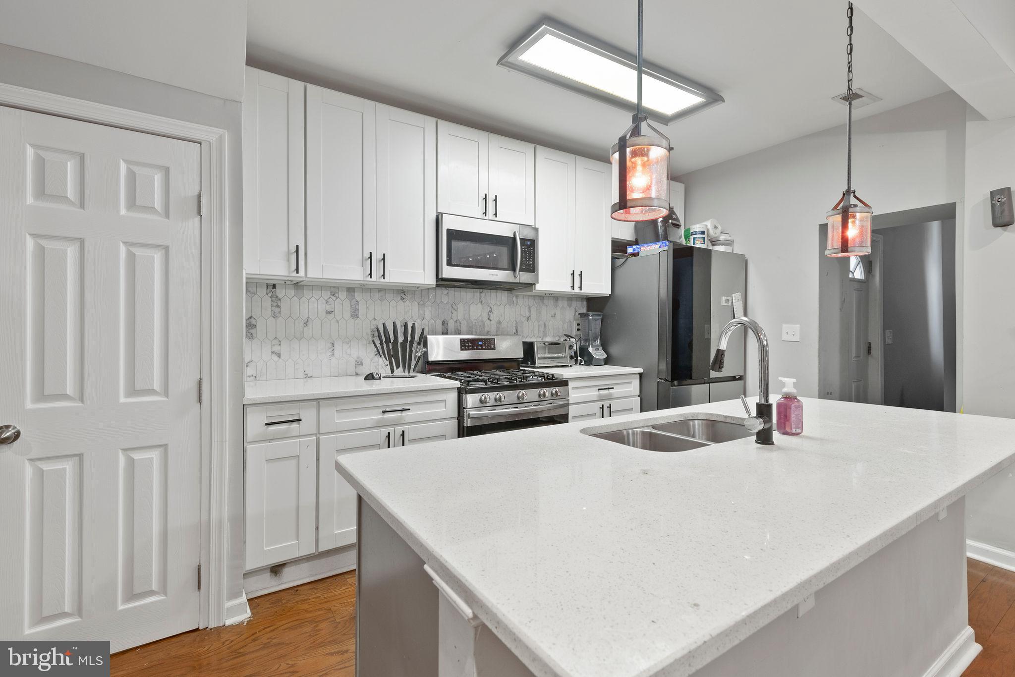 Welcome to 2017 Ruxton Avenue
**This property qualifies for the SWBC Community Lending Program** This program comes with rates about .25% less than market.
A beautifully maintained brick porch-front home thoughtfully renovated in 2020. Offering 4 spacious bedrooms and 2 full bathrooms across nearly 1,900 square feet of finished living space, this home blends modern upgrades with classic charm. The gourmet kitchen features white 42-inch cabinets, a striking quartz countertop island, custom backsplash, and stainless steel appliances, including a 5-burner gas stove. Enjoy elegant finishes like recessed lighting, tray ceilings, and hardwood flooring throughout the main level.
The fully finished lower level includes a private bedroom, full bath, and laundry area—perfect for guests or extended family. Bathrooms are updated with stylish tilework, vanities, and lighting. Additional highlights include central A/C, a programmable thermostat, carpeted bedrooms, and ample natural light.
Conveniently located near I-695, I-70, I-83, parks, the Baltimore Zoo, and shopping, this move-in-ready home offers the perfect blend of comfort, style, and accessibility. Don’t miss your chance to own this lovingly cared for home in a well-established neighborhood!