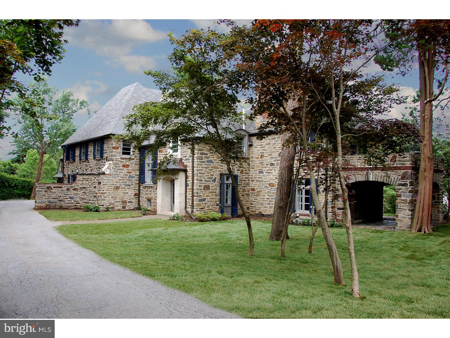 Recently completed masterful renovation of a stunning 1947, 5 Bedroom stone French Norman styled home. Positioned on an idyllic one acre parcel on a beautiful tree-lined street, the home offers classic exterior architecture with a fresh, open floor plan highlighted by a neutrally selected interior palette. Handsome stone floored Foyer offers sweeping iron stair and opens to a large Living Room with hardwood floors and marble surround fireplace. Two sets of French doors lead to a blue stone covered side terrace. A step down Dining Room is highlighted by soaring ceilings and an exit to full length rear terrace, with surrounding stone wall, ideal for expanded entertaining. Chic all white Kitchen with honed black granite counters offers stainless appliances including a five burner gas cook top, double wall overs and crisp white subway tile backsplash. A long center island offer-counter mounted sink and generous flat prep and storage space. Steps away find a Breakfast Area and through a wide, cased opening a large Family Room with wood burning fireplace and gleaming hardwood floors. Brightened by two walls of windows this family space anchors the informal area of the home and provides an uninterrupted flow between the spaces. Ascend the wide staircase to a generous Master Bedroom with his and her Master Baths with seamless shower and deep soaking tub. Four additional family Bedrooms and 4 full Baths are accessed by a wide hall and connect to the back stairs leading to the fully outfitted Mudroom and Laundry Room and 3 car attached Garage. Finished Lower Level with stone surround fireplace and built-in period bar provides additional recreation space and half Bath. A well-conceived, beautifully executed renovation - pristine.