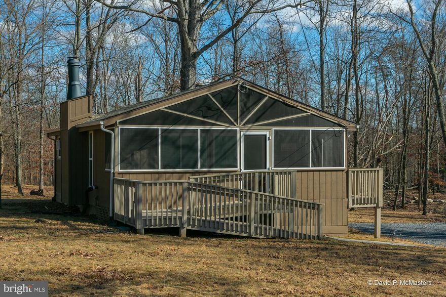 Escape to this cozy yet modern fully furnished cabin, nestled on a serene 0.70 acre lot surrounded by nature.  Thoughtfully updated with luxury vinyl plank flooring butcher block countertops, stainless appliances, this retreat blends rustic charm with contemporary comforts.  Relax in the inviting living room, or unwind on the screened porch, perfect for enjoying the sights and sounds of the the woods year round.  Designed  for convenience, the home also accommodates handicap assistance.  Outside, you'll find a shed for extra storage and plenty of space to explore and enjoy the great outdoors.  Whether you are seeking a weekend getaway or a full-time escape this cabin offer the perfect balance of comfort and nature.  This property does not offer membership to all of the amenities.  The Golf Course, restaurant, salon and spa are all available for public use.  Located just miles away from charming Berkeley Springs!