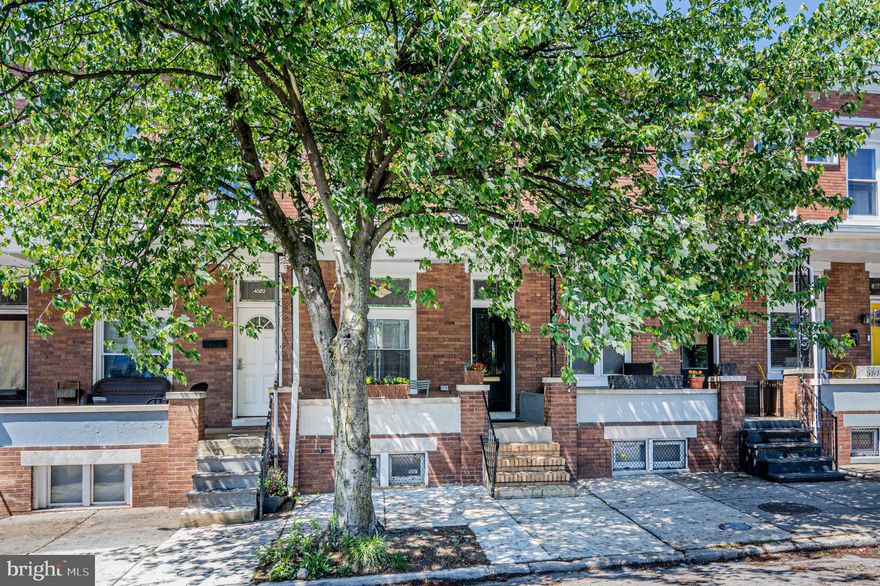 Welcome to 4022 Falls Road, a charming gem nestled in the historic neighborhood of Hampden in Baltimore, MD. The home has been lovingly restored by a professional interior designer who's mastery of minimalism and understanding of space, light, and color have created a bright, serene, and rejuvenating atmosphere that is an oasis for the soul. This home offers a perfect blend of modern amenities and classic charm not far from "The Avenue", the centerpiece of this eclectic community that offers an array of dining, shopping, and entertainment options. This 2 Bedroom, 1.5 Bath home exudes comfort and style. The inviting porch is the perfect place for watching folks stroll by while enjoying your morning coffee or unwinding in the evening . Enter through the front door with its heavy marble threshold and stand in the small, stained glass lit foyer that buffers the living area from the street and appreciate the original hardwood floors that have been restored to maintain their rustic charm and texture. The high ceilings, and bright walls make the main floor living area feel light, airy, and spacious. The huge front window brings in tons of light during the daytime, while hanging lamps and inset lighting provide the ability to set whatever mood you would like in the evening. The updated kitchen features ceramic tiled floors, solid maple cabinetry, stainless steel appliances, a large island, and shaker paneling with hanging pegs. Cabinets and paneling are painted in a neutral medium green that is the perfect antidote to the boring grey, white, black and granite color scheme all too common these days. There's plenty of light through the brand new paneled window, and plenty of storage in the butlers pantry. The upper level houses 2 beautiful bedrooms and a reading area/ office bathed in natural light pouring in through skylights. Restored transoms above the bedroom doors allow the natural light to spill in and fill the bedrooms with sunshine. People, Pets, and Plants will all thrive in this sunny little enclave. The unfinished basement is clean, dry, and freshly painted. It features a Pittsburgh Toilet and Sink configuration. Stop by to learn about this curious configuration so popular in homes built near factories at the turn of the 20th century. Pay special attention to the size of the floor joists to appreciate the quality and craftsmanship of this 1920 row home.  The home is equipped with updated roofing, wiring, furnace, water heater, and central air conditioning, ensuring peace of mind for years to come. Just out back there is room for two cars, or 1 car and a small patio. Don't miss the opportunity to make this meticulously restored home yours and experience the joy of living in Historic Hampden. Schedule a tour today and envision the possibilities of calling this place your new home!