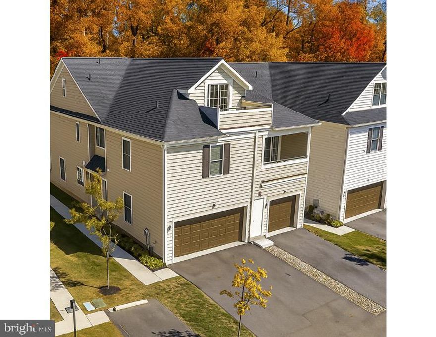 Welcome to 514 S Media Walk—a stunning 3-bedroom, 3-bath, upper-level two-story townhome offering 2,748 square feet of modern living across the 2nd and 3rd floors. Less than 1 mile walking to Trader Joes in downtown Media. Designed with both style and functionality in mind, this residence blends open-concept design with thoughtful details and abundant natural light from windows on both sides.

Media Walk is an intimate enclave of just 25 duplex and single homes, thoughtfully nestled amid wooded open space. Conveniently located and highly walkable, this community is rooted in tradition and designed to complement the surrounding neighborhoods of South Media and Media Borough.

At the heart of the home, the spacious kitchen features an elongated island ideal for entertaining, framed by oversized windows that flood the space with light. The adjoining living room provides seamless flow for gatherings or quiet evenings.

Also on this level, a versatile bedroom suite offers a full bath, walk-in closet, and flexibility to serve as a guest suite or primary retreat. A cozy flex space—perfect for a home office, gym, or family room—opens to a balcony overlooking the community. Down the hall, another full bath accompanies a second private bedroom or office with its own walk-in closet, offering adaptability for any lifestyle.

Upstairs, retreat to the massive owner’s suite with two private balconies, complete with a spacious walk-in closet and spa-like bath with dual vanities and a water closet. Across the hall, a generous flex space opens to the largest balcony, ideal for outdoor living or relaxation.

With three balconies, oversized windows, and thoughtful layouts, this home brings the outdoors in at every opportunity. Add in a two-car garage plus two driveway parking spaces, and you have a rare combination of convenience, space, and style—all in a prime Media location. Blending style, comfort, and convenience, 514 S Media Walk is ready to welcome its next owner.