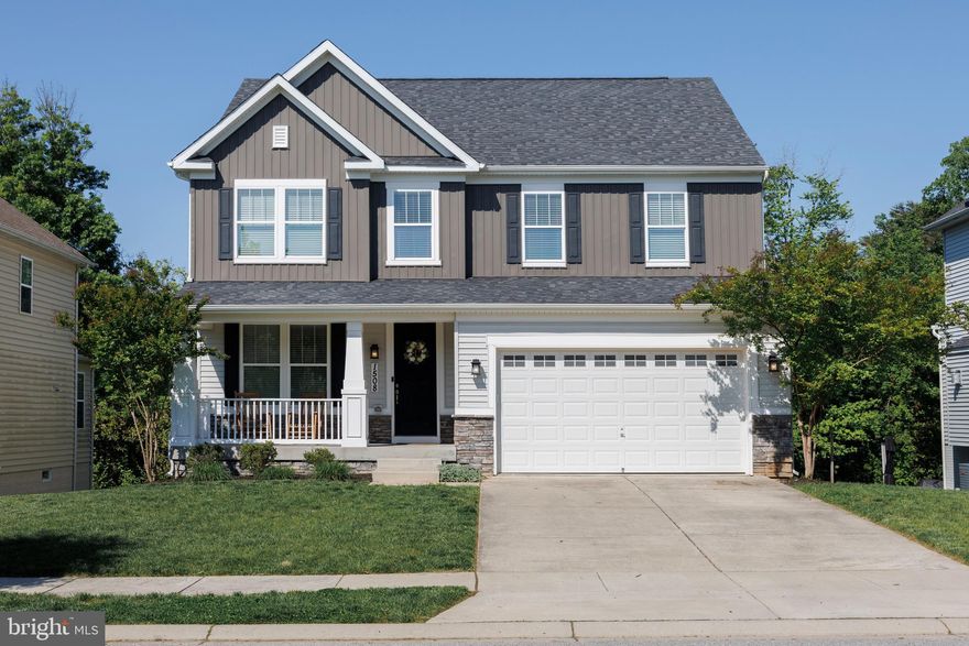 Tucked away on a private street leading to a cul-de-sac and backing to forest conservation, this beautifully updated 4-bedroom, 2.5-bath Colonial offers the perfect blend of privacy, style, and functionality. The freshly painted main level features 9-foot ceilings, engineered hardwood flooring throughout, and a dedicated office with custom white built-in cabinetry and shelving. The inviting living room showcases a gas fireplace with stunning shiplap surround, while the designer kitchen impresses with white soft-close cabinetry, granite countertops, expansive island with pendant lighting, brick backsplash extending to the ceiling, 5-burner gas range, chimney-style vent hood, recessed lighting, and stainless steel appliances. A thoughtfully designed mudroom includes custom built-in cubbies, soft-close cabinetry, and convenient shoe storage. Upstairs, the elegant wood staircase features stained treads, white risers, and a carpet runner leading to the spacious primary suite complete with a coffered ceiling and LVP flooring. The luxurious primary bath offers a walk-in glass-enclosed shower with herringbone-pattern white subway tile, double vanities with granite countertops, white cabinetry, and oversized 12x24 ceramic tile flooring. The unfinished walk-out basement provides endless potential with 9-foot ceilings, two full-size windows, and a full bath rough-in ready for future expansion. You don't want to miss this!