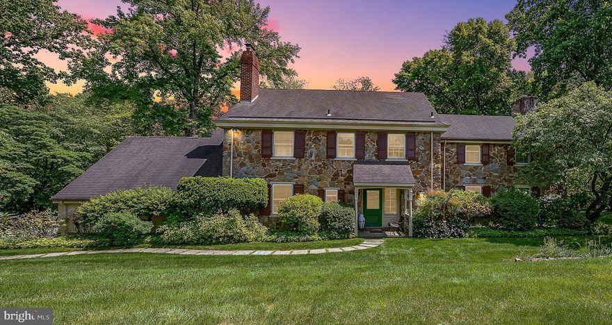 This classic 5-bedroom stone colonial home, set on a picturesque 1-acre lot in the walkable neighborhood of Gladwyne, PA, is just a short stroll from various town amenities, including a new grocery store, charming restaurants, a library, a public park, and tennis courts. The home’s transverse foyer plan features warm hardwood flooring with variable width planks, leading to a cozy fireside den/office and a large formal living room with lots of natural light and a wood-burning fireplace. Rich millwork and a wall of windows offer views of the lush rear yard and a serene screened stone terrace, accessible from the adjacent formal dining room via a Dutch door. Crown moldings and chair rails add to the allure of this traditional Main Line home. The kitchen is equipped with stunning granite countertops, a Wolf induction range, a SubZero fridge, and a cozy breakfast area. It opens seamlessly into a spacious family room with French door sliders leading to the terrace. A discreet back stairway leads to a fifth bedroom with an attached full bathroom, ensuring privacy for long-term guests or additional living quarters. Upstairs, the primary suite features three exposures, multiple closets, and a private bath. Three additional large bedrooms include one with an en suite bath, while the remaining bedrooms share a well-appointed hall bath. The lower level offers excellent recreational and storage space. Outside, the beautifully landscaped lawn features numerous specimen plantings, creating a tranquil retreat, with an irrigation system to maintain the grounds. The outdoor space includes a spacious backyard and a well-maintained front yard. The property also features a generator for added safety and an attached garage with on-site parking for multiple vehicles. This home is quietly set back from the street, providing privacy while remaining conveniently close to the City, International Airport,  and major routes for easy travel.