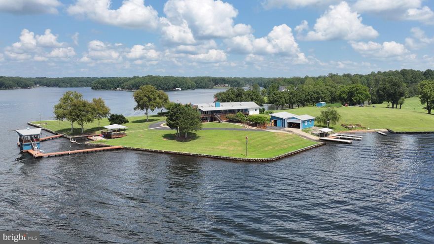 Positioned on one of Lake Anna’s most extraordinary point lots, this deep-water estate offers incomparable, breathtaking panoramic views, unmatched privacy, and a proven business opportunity. Encompassing 1.55 acres of fee-simple land, an additional 1.66 acres of Dominion Shoreland, and an impressive 1,260 feet of bulkheaded shoreline, this property is truly without equal. Words cannot convey the tranquility and joy that one feels as they enjoy the expanse of this waterfront property.

The expansive lake views will take your breath away and soothe your soul. Every thoughtful feature of this property will heighten your time with family and friends, creating priceless, lasting memories. Designed with intention, every detail enhances the lakeside experience. Outdoor amenities include shaded gathering areas, whimsical birdhouses, three inviting gazebos, a tranquil koi pond, and a variety of recreation and entertainment spaces. Whether hosting family reunions, elegant weddings, or corporate retreats, the property seamlessly adapts to every occasion. 

With a loyal base of repeat renters returning year after year, this established destination offers not only a private sanctuary but also exceptional income potential. Already established as a premier rental and event venue, this waterfront estate provides a rare opportunity to enjoy the best of Lake Anna while benefiting from consistent income potential. This home was originally built in the 1960s, before the lake construction had begun. The current owner purchased it in the early 1990s and began cultivating his vision for this 5,200+ sq. ft. home, where he could entertain any number of friends and family. He also enjoyed the ability to have his ultralight seaplane and keep it in its own hangar, with an adjoining RV garage, along with numerous lake toys for the ultimate lake lifestyle. While the home is understated, its seven bedrooms and 6.5 bathrooms welcome family, friends, and renters who delight in the location and the ease with which they can dine, swim, and play in the privacy of the ultimate lake setting.

For investors, the potential of this property as a vacation rental or as a destination wedding venue could bring your dreams to fruition.  Let your imagination bring this property to a new level of spectacular.  

See the feature sheet in Documents for amenities too extensive to list here.