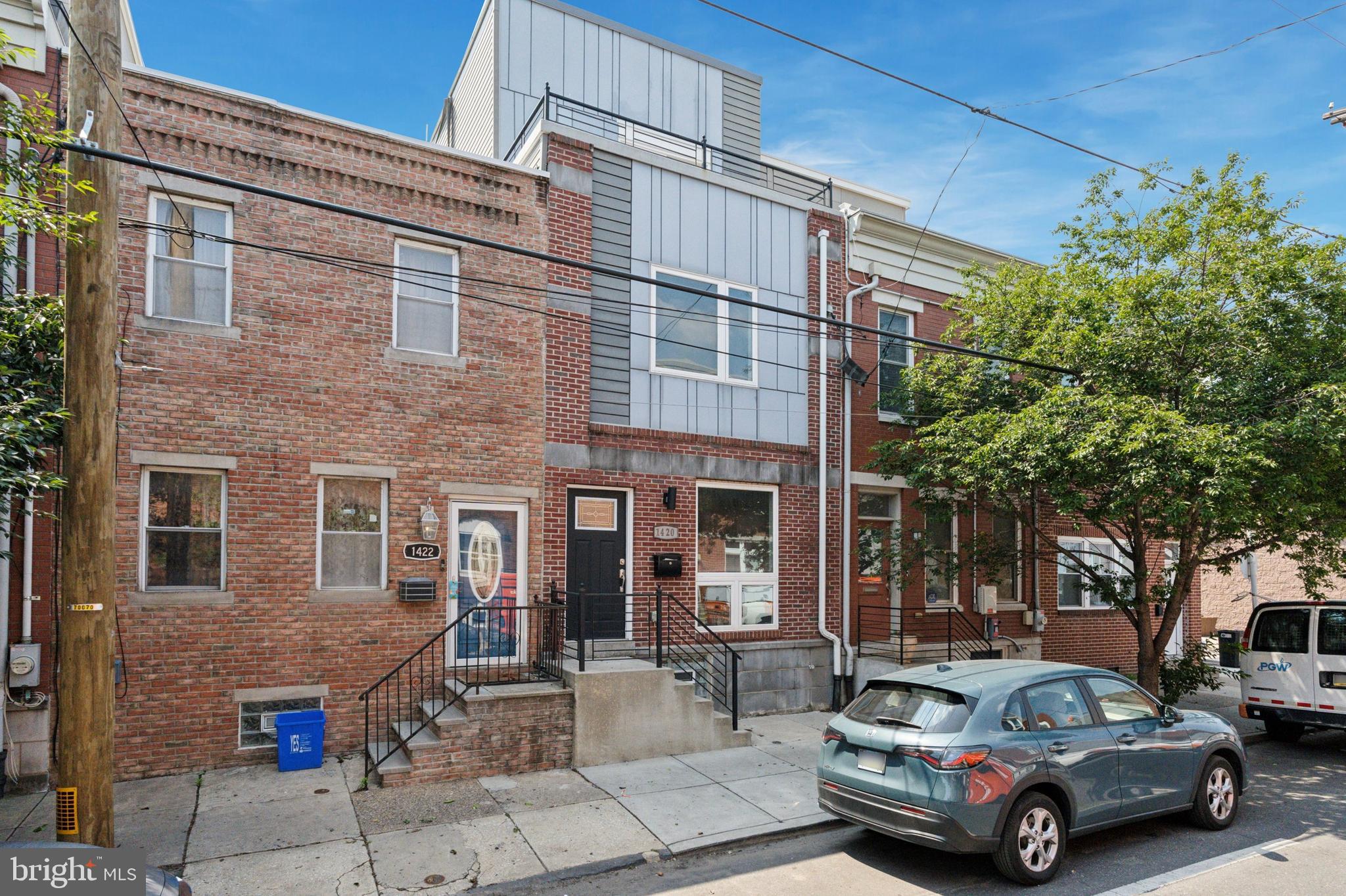 Come see this beautiful single-family townhouse in the Point Breeze neighborhood of Philadelphia, PA. The house boasts three bedroom and two and a half bathrooms, hardwood floors, high ceilings, recessed lighting, and an open floor plan. The dining room features a geometric wood wall and a powder room. The kitchen is a chef's dream with stainless steel appliances, spacious counters, a marble subway tile backsplash, slow-closing cabinets and drawers, a five burner gas stove with griddle and a pot filler and beautiful pendant chandelier lights over the waterfall island & bar. The sliding glass doors lead to a spacious concrete patio and yard space.
Move to the second floor, you'll find two spacious bedrooms with ample closet space, laundry room and a full bathroom. The third-floor primary suite features a full bathroom with a soaking tub, two separate vanities and and a large walk-in shower. The oversized bedroom includes generous walk-in closets and sliding doors that lead to a balcony with beautiful views of the skyline perfect for morning coffee or a place to unwind at the end of the day.
And don't forget the roof deck, which offers stunning views and also a beverage fridge so you can entertain friends and family.
Lastly the finished basement offers endless possibilities, such as extra living space, a home office. or a private gym. Don't miss your opportunity to view this beautiful home in person.