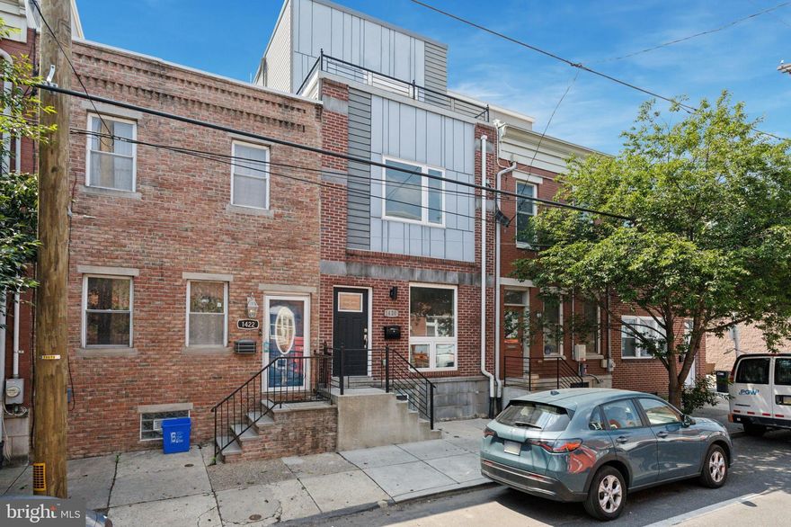 Come see this beautiful single-family townhouse in the Point Breeze neighborhood of Philadelphia, PA. The house boasts three bedroom and two and a half bathrooms, hardwood floors, high ceilings, recessed lighting, and an open floor plan.  The dining room features a geometric wood wall and a powder room.  The kitchen is a chef's dream with stainless steel appliances, spacious counters, a marble subway tile backsplash, slow-closing cabinets and drawers, a five burner gas stove with griddle and a pot filler and beautiful pendant chandelier lights over the waterfall island & bar.  The sliding glass doors lead to a spacious concrete patio and yard space.

Move to the second floor, you'll find two spacious bedrooms with ample closet space, laundry room and a full  bathroom.  The third-floor primary suite features a full bathroom with a soaking tub, two separate vanities and and a large walk-in shower.  The oversized bedroom includes generous walk-in closets and sliding doors that lead to a balcony with beautiful views of the skyline perfect for morning coffee or a place to unwind at the end of the day.

And don't forget the roof deck, which offers stunning views and also a beverage fridge so you can entertain friends and family.

Lastly the finished basement offers endless possibilities, such as extra living space, a home office. or a private gym.  Don't miss your opportunity to view this beautiful home in person.