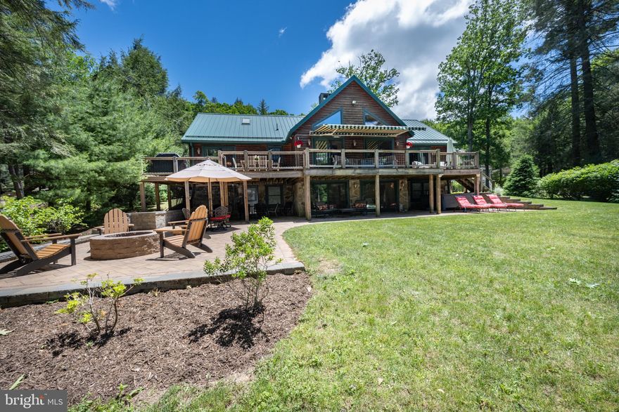 A remarkable log home with stunning contemporary elements throughout. Located on 101’ of LEVEL lakefront in a calm deep-water cove, this elegantly remodeled 5 bed 4 bath home has all new HVAC systems, updated bathrooms, floating glass lighted staircase, with hard wood floors and granite tops throughout.  The kitchen and dining area are well thought out for entertaining with an open kitchen and dining area which includes a sitting area off the kitchen to enjoy expanded entertainment. The magnificent, stacked stone wood burning fireplaces are the center piece of both the main floor, and the walk-out basement living rooms. Spacious game room on the lower level includes a separate 2nd living room.  There is a private loft with full bath for a 2nd Primary Suite upstairs. Three levels of living space with year-round views of Evergreen and Deep Creek Lake, with plenty of windows to let in the natural light and beauty. If the inside doesn’t wow you, just step outside to the sprawling back deck and patio with built in fire-pit and Hot Springs brand salt water hot tub, all providing abundant indoor/outdoor living space. Plenty of level parking with a large black top parking area with two garages attached to the house, and a third 2-car garage with a framed-out loft area located directly across the street. The location of this home provides a very rare opportunity to own both sides of highly sought after Lake Shore Dr. Lots of storage for all your winter and summer toys! All this and much more… Call today for details.
