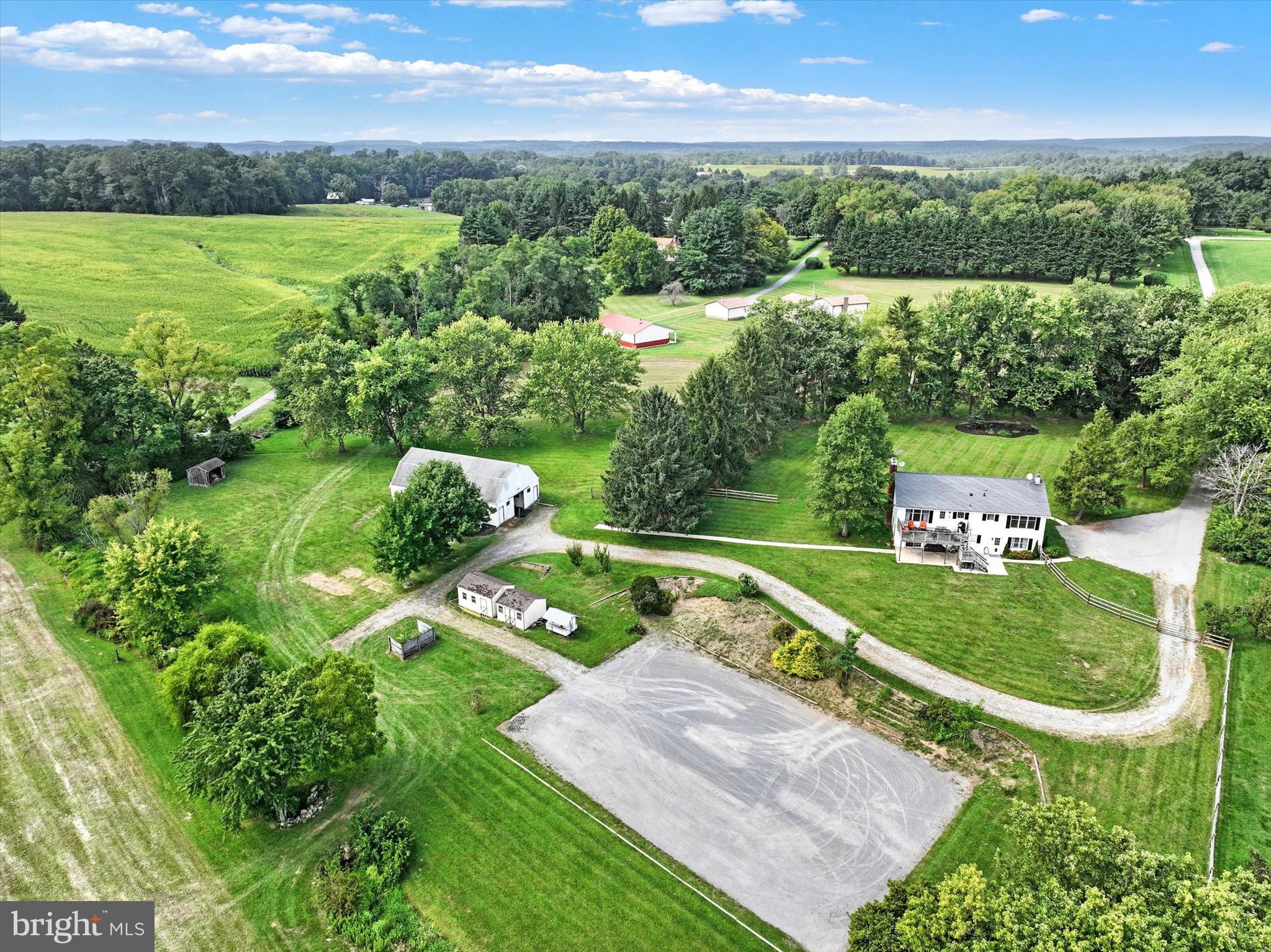 Nestled on just over 9 picturesque acres, this charming farmette offers a perfect blend of country living and modern comfort. The beautifully updated home boasts serene pastoral views from every window, set back off the road and surrounded by farm lands, creating a peaceful retreat in the heart of Parkton. Equine enthusiasts will appreciate the well-equipped barn with 6 stalls, and 3 additional stalls to utilize for wash, feed, and storage plus a hayloft, automatic waterer and riding arena. Whether you're looking to cultivate a small farm or simply enjoy the tranquility of rural life, this property provides endless possibilities. A beautiful home with hardwood flooring throughout the main level, 4 bedrooms, and 3 completely renovated full baths. Geothermal system for the most efficient heating and cooling and Hereford schools!