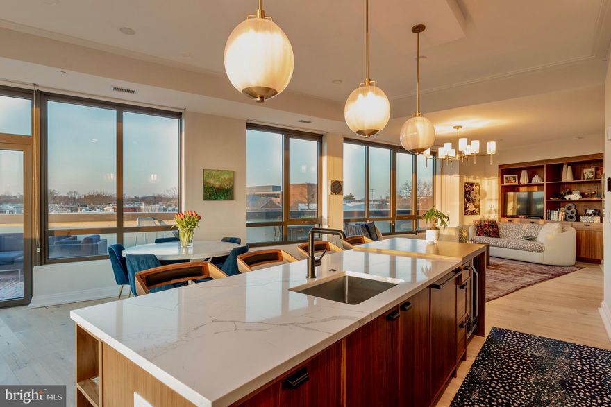 No address is more synonymous with Washington, DC than Pennsylvania Avenue, and 1111 Pennsylvania Avenue, SE presents a truly exceptional opportunity to experience it at its finest. This spectacular, sun-drenched corner penthouse at Penn Eleven offers what is arguably among the most extraordinary Capitol views of any luxury condominium—an ever-changing backdrop of iconic beauty just steps from the Capitol itself.

Built in 2019, this expansive two-bedroom, two-bath residence is wrapped in glass and seamlessly extends to more than ninety linear feet of adjoining terrace, creating a rare indoor-outdoor living experience. Sweeping panoramic views and abundant natural light define every space, elevating both everyday living and entertaining. Designed to set a new benchmark for luxury on Capitol Hill, Penn Eleven showcases the highest level of craftsmanship and finish. Wide-plank white oak hardwood floors run throughout, complementing a true chef’s kitchen appointed with a generous center island, custom micro-shaker cabinetry, gas cooking, and premium Bosch appliances.

Both bedrooms are thoughtfully positioned along the terrace, featuring floor-to-ceiling windows, custom built-ins, and exceptional natural light. The primary suite is a private retreat, complete with a spacious walk-in closet and a spa-inspired bath finished with Carrara marble, quartz, porcelain tile, Waterworks fixtures, and an oversized soaking tub.

Additional highlights include a gracious entry foyer, abundant storage, and secure garage parking. Penn Eleven is an intimate boutique building of just 34 residences, offering a full-time weekday concierge, a beautifully designed lobby, and a rooftop terrace with gas grill and sweeping city views.

Perfectly positioned just blocks from Rose's Luxury and other Michelin-starred dining, vibrant shopping, and neighborhood nightlife, and only three blocks to Metro, this premier location also offers effortless access to Downtown Washington and Reagan National Airport. This is Capitol Hill penthouse living at its most refined—an extraordinary offering not to be missed.