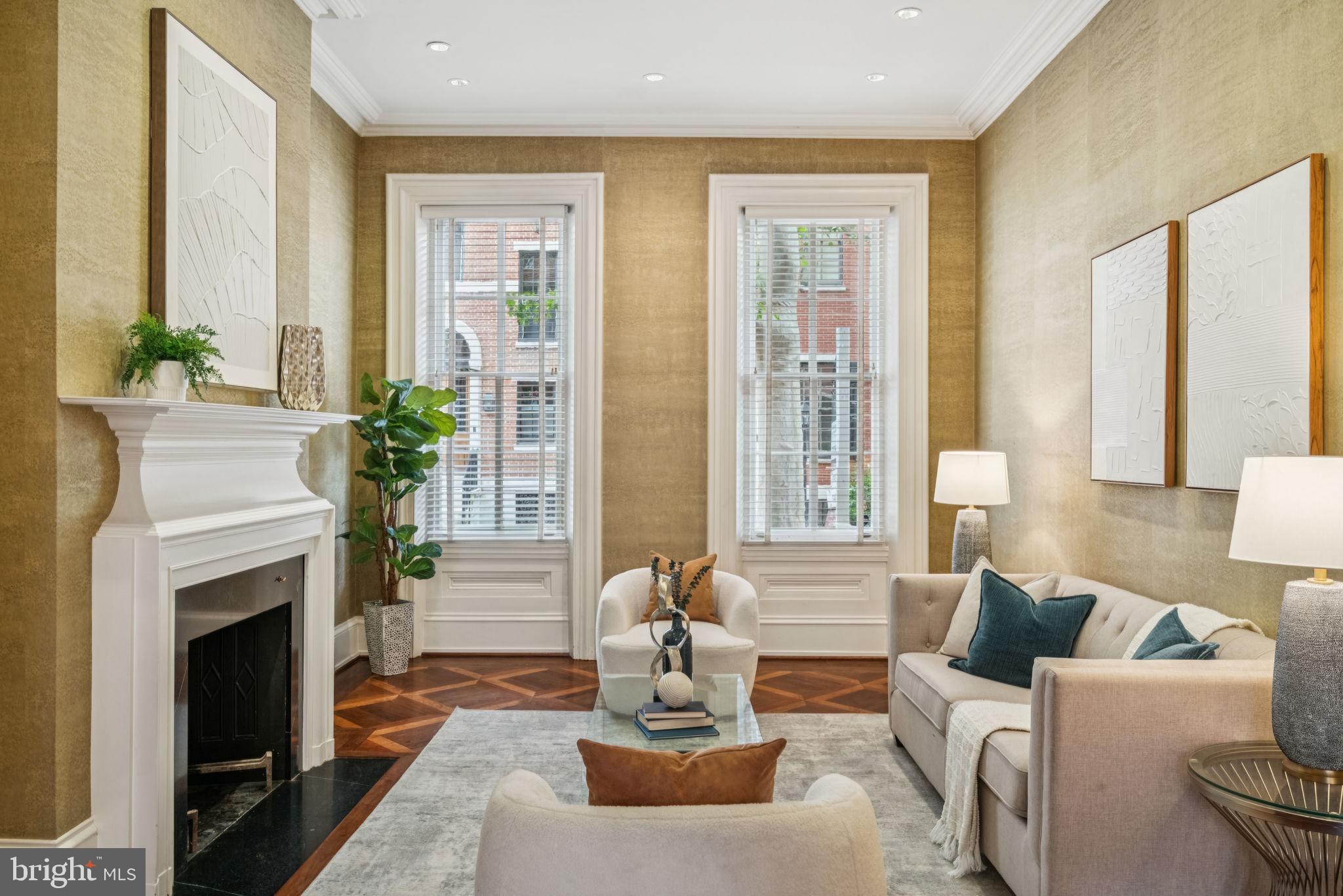 Welcome to 1818 Delancey Place—a magnificent 20-foot-wide historic residence with Garage Parking, nestled on one of Philadelphia’s most iconic and coveted blocks. Just one block from Rittenhouse Square, this elegant Federal-style home offers over 4,300 square feet of sun-drenched, beautifully proportioned living space, blending timeless architectural detail with modern comfort and flexibility.
Enter through dual arched foyers and ascend two marble steps into a grand, light-filled formal dining room with soaring 12-foot ceilings, intricate crown moulding, and a stately original fireplace. A decorative niche provides the perfect spot to showcase artwork, creating a striking focal point. Custom inlaid flooring flows gracefully through the main level, visually connecting each space. A large archway leads to the refined living room at the front of the home, where tall windows overlook tree-lined Delancey Place and its distinguished facades, filling the space with natural light. Just off the dining room, French doors open to an intimate deck—also accessible from the spacious eat-in kitchen—perfect for morning coffee or evening cocktails.
The expansive kitchen is anchored by a large, south-facing window that floods the space with natural light. With abundant cabinetry and generous proportions, it's ideal for designing your dream chef’s kitchen. A wide hallway connects the kitchen to the dining area and includes a coat closet, powder room, and access to the basement.
The second floor features a sunlit, oversized library at the top of the stairs, complete with custom bookshelves, a wood-burning fireplace, and an adjacent wet bar—perfect for reading, relaxing, or entertaining. At the front of the home, the luxurious primary suite features high ceilings, tall windows, recessed lighting, and a decorative marble fireplace. Dual closets—including a walk-in—lead to the spacious en-suite bath, a marble-and-tile retreat with spa-like elegance.
On the third floor, you’ll find two generously sized bedrooms with high ceilings, ample closet space, and en-suite baths. The front bedroom includes a private dressing room, while the rear bathroom exudes vintage charm with a clawfoot tub and beautiful tilework.
The fourth floor offers a versatile front room with original random-width hardwood floors and a large skylight—perfect for a bedroom, studio, home office, or playroom. This level also includes a half bath, additional closets, and access to a potential roof deck. A bonus room adds flexibility as a gym, creative studio, or luggage room.
The partially finished basement features a spacious laundry room with double soaking sinks, a temperature-controlled wine cabinet, a half bath, ample storage, and direct access to the one-car garage via a heated driveway on Panama Street.
Additional highlights include three working wood-burning fireplaces, three-zone HVAC, and built-in surround sound. With its unparalleled location, rich history, and expansive layout, 1818 Delancey Place is a rare opportunity to own a truly exceptional home on Philadelphia’s most admired street.