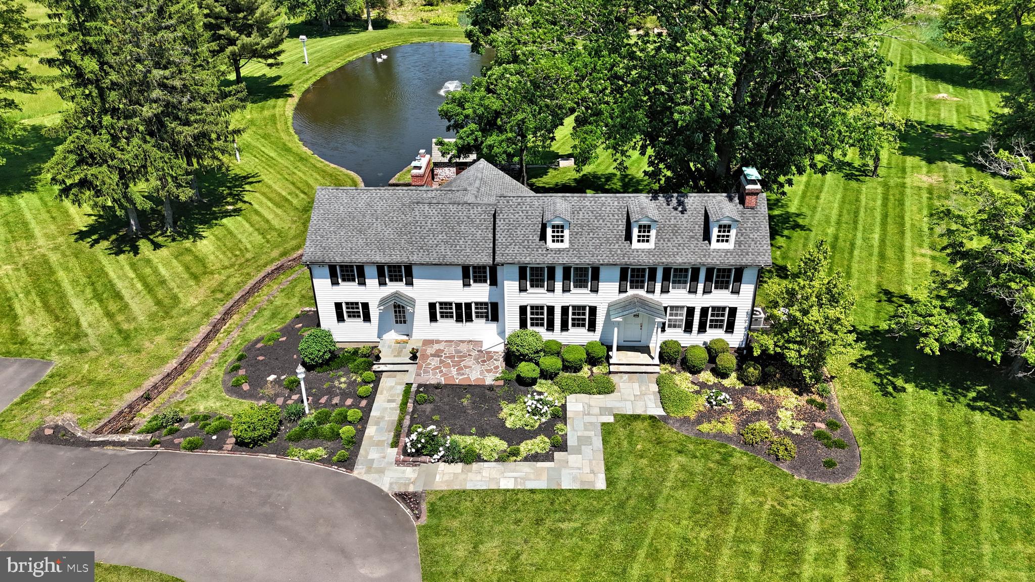 Rarely does a property of this magnitude became available in such a highly sought after location. This splendid offering, with a home that a portion of which dates back to 1750 and one of the most spectacular ponds you will find anywhere, is now available to purchase. Thoughtfully updated many times along the way, a gated entry and long driveway reveal a magnificent natural setting. Featuring 3/4 bedrooms, original pumpkin pine floors, the home is a picture perfect rendition of a colonial era farmhouse modernized for today's living. Neutrally appointed, quite spacious throughout, and full of natural light with long distance views from many vantage points, the home is in mint, turn key move-in condition, and it will feel like "home" from moment you enter. The gourmet kitchen features high end appliances, marble counters, island seating for four and adjoins the family room and three seasons sunroom, making this space ideal for entertaining. The office/library has built-ins and a wall of windows with long distance views. The formal dining room can accommodate a large gathering, and the original "keeping room" is flexible space for use as a formal living room or breakfast room. A laundry room and powder room complete the main floor. The upper floor reveals the beautiful Primary Suite and huge Primary bath, bright and airy bedrooms 2 and 3, spacious hall bath, a bonus room that could be for entertainment, quiet study, or use as bedroom 4, and large walk-in hall cedar closet. There is also basement access from inside the house and outside as well. Once outside, the timeless Bank Barn has multiple levels and is in immaculate condition as well, a two car garage and additional carport will house up to 10 cars under cover. A well appointed small animal barn with stalls, multiple pastures, idyllic pond and pump house, and ample open space and woodlands make this an outdoorsman's paradise. This most distinguished offering consists of three contiguous parcels totaling 46+- acres. Although the properties are in conservation and cannot be sub-divided, a generously sized building envelope will accommodate a permitted additional home and ancillary uses, and additional structures. Coupled with the connection to natural gas ( w/ whole house backup generator ), the home is connected to public water and public sewer, a rarity for a property of this age and magnitude. All of this plus super low taxes equals a once in a lifetime opportunity to acquire a legacy Bucks County Farmhouse property located in the Heart of the Council Rock School District, just minutes to Newtown Boro.