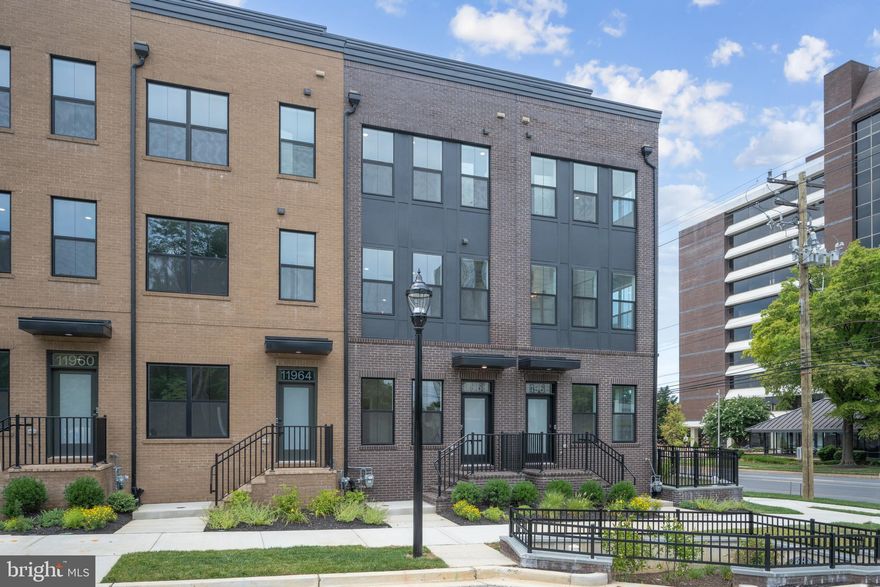 Step inside the open an airy main living level where you will find a Chef’s dream kitchen, light-filled dining room, and large great room that opens to the outdoor living.  The kitchen is complete with Ethereal Noctis quartz countertops, Sepia cabinets, KitchenAid appliances, and warm brass finishes. Upstairs boasts a luxe primary suite with huge walk-in closet and two secondary bedrooms.  The third floor features rooftop terrace, covered outdoor living, and a large loft that is the perfect flexible space.  A spacious open rec room completes the lower level.