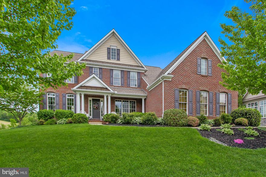 Stunning custom built Charter home in the desirable Springwood Neighborhood in Dallastown School District. Situated on a lovely landscaped 1 acre lot with impressive curb appeal and over 5200 square feet of living space, this home stands out! The grand 2 story foyer welcomes you into an open floor plan where you can move from room to room admiring the beautiful windows that bring in so much natural light. The dual staircase, 9  ceilings, and attractive hardwood floors throughout the first floor are just some of the highlights of this home. There is a formal living room and elegant formal dining room with a tray ceiling and decorative wainscoting. You will find a well designed kitchen that features quartz counters, dining area and is open to the spacious family room with gas fireplace. The luxurious master bedroom suite features a tray ceiling, walk in closet and very large master bath with double vanity, garden tub and separate ceramic tile shower. There are 3 additional bedrooms on the second floor, each with a walk in closet and access to a full bath. There is lots of room to entertain in this home, especially in the walk out finished basement where you will find a large family room that features a bar with built in shelving and access to the covered patio and hot tub that you can enjoy year round! Also, this space could be used for separate living quarters as it has a 5th bedroom, sitting area and full bath. Enjoy relaxing on the maintenance free trex deck looking out onto the large rear yard that backs up a park like setting. This fabulous is located in a great location, close to golfing, restaurants and shopping. Plus convenient to I83, great for the commuter. Call to schedule a private tour!