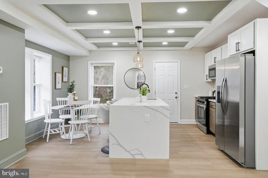 Beautifully remodeled and move-in ready, this 3BR/2BA end-of-row townhome is located a quiet neighborhood.  Make your way to the covered front porch and step into your forever home.  This home offers an open main floor plan, custom tray ceilings, a warming color palette, abundant natural light, a see-though staircase wall, and luxury flooring.  The main floor boasts a large living room and a stunning kitchen with a dining area.  The kitchen features two-tone cabinets, sleek quartz countertops with a subway tiled backsplash, stainless steel appliances, and a stainless sink set into an island with a waterfall edge, pendant lighting, and breakfast seating for three.  The second floor has three newly carpeted bedrooms: two sizable secondary bedrooms, a larger primary bedroom with a double closet, and a newly remodeled full bathroom. The lower level offers additional finished living space, including a large family room, a full bath with a walk-in shower, laundry, storage, and a walk-out to the newly fenced yard.  From the main floor step outside onto a newly constructed wood deck that overlooks a backyard and a side yard, which connects to the front yard, all with so many possibilities. This move-in-ready home is ideal for any new homeowner, and is located near shopping, restaurants, and commuter routes.