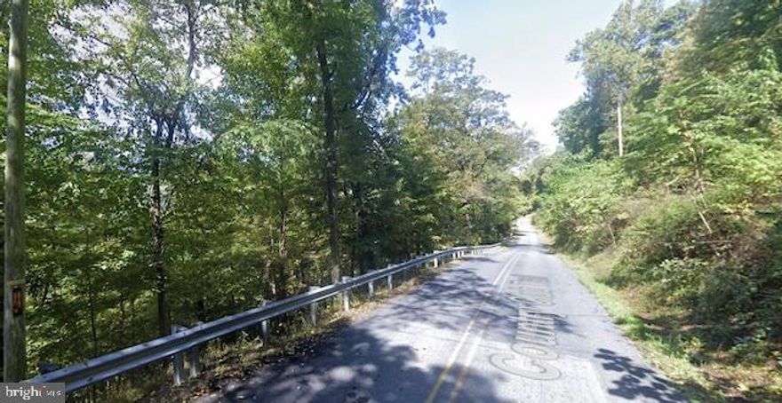 Bring your vision to life on this 0.99-acre hillside lot located on Sidetrack Trail. The property offers a wooded setting with a steep slope, ideal for a unique build with character. No water source or septic system approval is currently in place. Buyer to verify availability of utilities and obtain necessary permits.