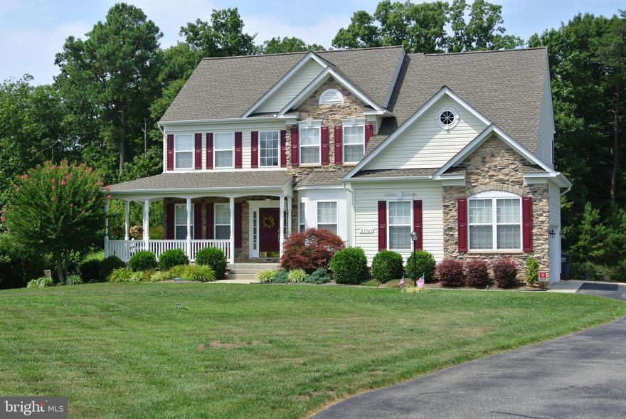 Stunning Colonial at the end of a Cul-De_Sac. Enjoy Morning Coffee on the Wrap Around Front Porch.  Relax on the Paver Patio after a hard days Work.  Enjoy the tranquility of Nature in the Tree Lined back yard.  The cook in the family will love the huge kitchen with Newly Updated Granite Countertops and Ceramic Tile Backsplash and a Walk In Pantry.  Working from home is a breeze with High Speed internet and your own First Floor Office. The family room features 10ft Ceilings, the Primary Bedroom features vaulted ceilings. Plenty of room for future expansion with a 1400SqFt unfinished basement that features 9 Ft Ceilings and a rough-in for a full bathroom.  New Roof as of April 2018. Amish Built Shed. Fresh paint in many rooms. Driveway freshly sealed. Oversize Garage.  New Vinyl Privacy Fence in Backyard as of 2020. Paver Patio includes walls with wall lights.  Front and Back Yards Professionally Landscaped. The open floor plan makes this the perfect home for entertaining and family gatherings.  The landscaping with natural decorative grasses create a green fence in the back yard.  This well maintained home shows pride of ownership at every turn.  Great commuter location for Pax River or DC.  Park and ride lots just a short distance away.  Close to  Schools, Shopping and the Amish Markets.