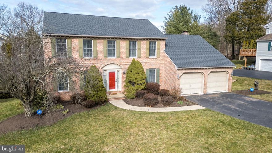 With almost 2600 sq ft of living space plus a HUGE walk out basement, two car oversized garage and immense rear deck overlooking open space and trees this home is one you will not want to miss! Center hall brick front colonial custom built by Chester Scholl offers a large formal living and dining room,  expansive kitchen with stainless steel appliances, peninsula bar seating, center island with butcher block top, and timeless raised panel oak cabinetry.  Kitchen opens to gorgeous cathedral ceiling family room with floor to ceiling brick fireplace and patio doors leading to rear deck. First floor laundry and powder room. Dining room has wood floors with lovely moldings and trim (chair rail, crown molding, wainscoting).  Ceramic tile from foyer through kitchen-breakfast room, and laundry. Second floor offers four bedrooms, two full baths (both with double vanities). Ensuite master wing boasts a walk in closet bigger than most bedrooms with an adjoining walk in cedar closet. The full basement is walk out to the rear yard with great height and ready to finish to your specifications. Public utilities, natural gas heat, central air and an unbelievable setting with babbling brook and private rear yard. Outstanding curb appeal.