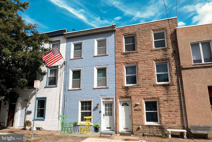 Welcome home to this charming 3 story Trinity in the heart of Fairmount, set along a picturesque tree lined street just blocks from the Art Museum. Originally designed for artisans and tradespeople, this historic “jewelry box” of a home thoughtfully maximizes space while preserving classic character. Random width cherry hardwood flooring runs throughout all three levels, complemented by an exposed brick accent wall, recessed lighting, and large windows that fill the home with natural light. The inviting Great Room features hardwood floors, a large window, recessed lighting, and a convenient coat closet. The fully renovated kitchen boasts gray shaker style cabinetry, striking black granite countertops, tile flooring, gas cooking, a built in stainless steel microwave, dishwasher, and recessed lighting. An exposed brick wall and space for a café table sit beside sliding glass doors that open to the private patio. The fully enclosed paver patio is a true city bonus, complete with a mural in classic Philly style, exterior lighting, and a raised privacy wall—perfect for relaxing or entertaining. Up the distinctive pie shaped stairs, the second level offers an oversized bedroom with a sitting area, hardwood flooring, dual windows, and a 10’ walk in closet. A generously sized, just-renovated full bathroom features a modern white vanity and medicine cabinet, white tub/shower, and window. The third floor adds an extra large bedroom with sitting area, hardwood floors and ample closet space. With a full-sized, walk-out door to access to the roof, (truly a Pinterest dream), possibilities abound offering skyline views of the city and endless potential. Additional features include a basement with washer and dryer, economical gas forced air heat, central air conditioning, gas hot water heater, updated electric, replaced sewer line, and vinyl replacement windows. Plus, every room has a closet which enhances both functionality and comfort. This coveted Trinity expands your idea of tiny home living, offering style, charm, and livability in one of Philadelphia’s most desirable neighborhoods. The location can’t be beat—surrounded by cobblestone streets, thriving mom and pop shops, cafés, and high end new construction. Enjoy easy walking access to museums, Kelly Drive trails, the Schuylkill River waterfront, and East Fairmount Park—all less than a mile away. Showings start Saturday, March 28!