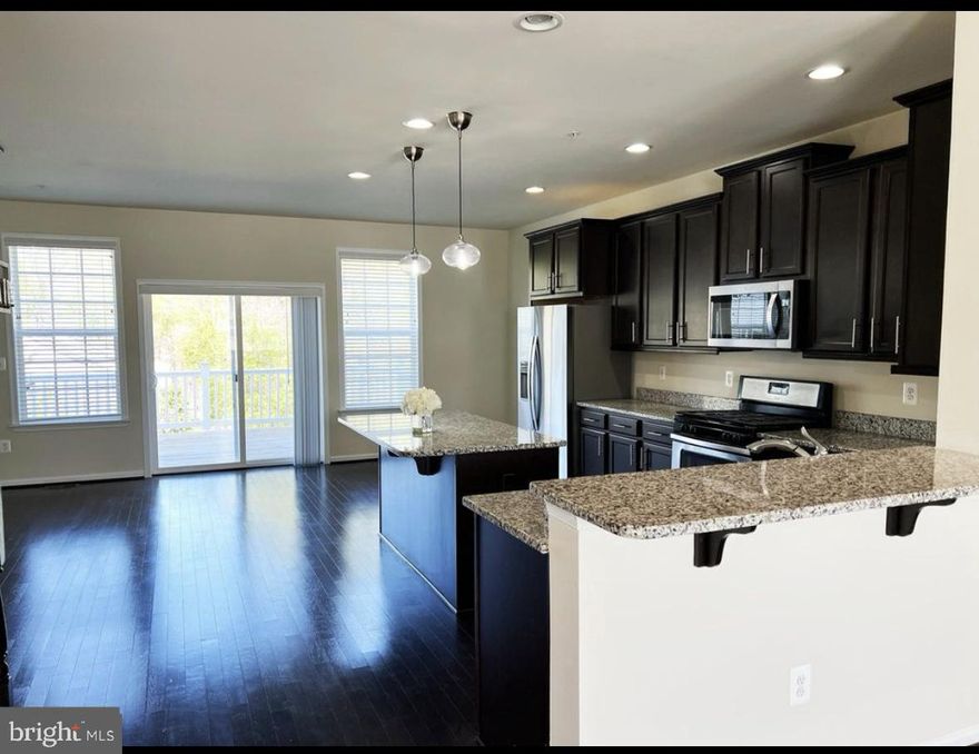 Gorgeous End Unit Brick front with almost 3,000 square feet of space lots of Natural light beautiful hardwood floors high ceilings huge rooms primary bedroom with cathedral ceilings two walk in closets private bath with double sinks walk in shower soaking tub luxurious custom tile great kitchen with lots of counter and cabinet space high grade 42 inch cabinets and granite counter tops stainless-steel appliances 
upper-level laundry room with high washer and dryer recessed lighting great outdoor space excellent views on this private deck lower level with spacious rooms and private full bath indoor garage with access to lower level across from play area VERY QUIET NEIGHBORHOOD
SELLER WILL PAY BUYERS CLOSING WITH ACCEPTABLE OFFER ALSO POSSIBLE TO BUYDOWN INTEREST RATE