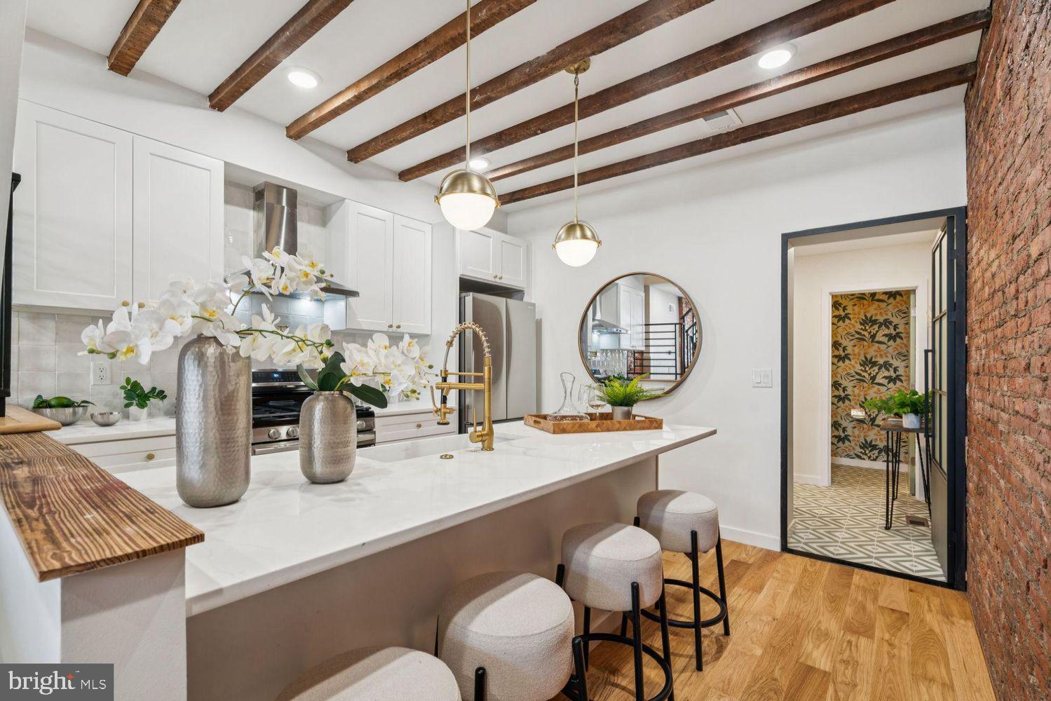 Welcome to 2327 Belgrade Street—a thoughtfully renovated 2-bedroom, 1.5-bathroom home located in the heart of vibrant Fishtown, complete with a 10-Year Tax Abatement. Blending timeless character with modern upgrades, this home offers the perfect mix of historic charm and contemporary style.
Inside, you’re greeted by wide plank solid oak hardwood floors, exposed ceiling beams, and abundant exposed brick that bring warmth and texture to every corner. The inviting living area features a custom accent wall with exposed brick and shiplap detailing, adding depth and visual interest.
The chef’s kitchen is as functional as it is beautiful, boasting an extended quartz island, farmhouse sink, shaker-style cabinetry, designer brass hardware, stainless steel appliances, and a custom tile backsplash. A striking exposed brick wall and black-framed industrial door lead into the bright mudroom, complete with a full-sized stacked washer/dryer and a stylish half bath.
Out back, a private rear patio offers the perfect space for outdoor dining, gardening, or relaxing under the city lights. Upstairs, you'll find two comfortable bedrooms and a well-appointed full bathroom featuring a tiled tub surround and gold fixtures. The primary bedroom includes an expanded closet and a charming exposed brick accent wall. The unfinished basement provides additional space for a home office, gym, or storage.
Enjoy unbeatable walkability to local favorites like Green Eggs Café, Riverwards Produce, Loco Pez, ReAnimator Coffee, and Martha—plus easy access to I-95 for commuting. This home checks all the boxes and is ready for its next owner. Don’t miss out!