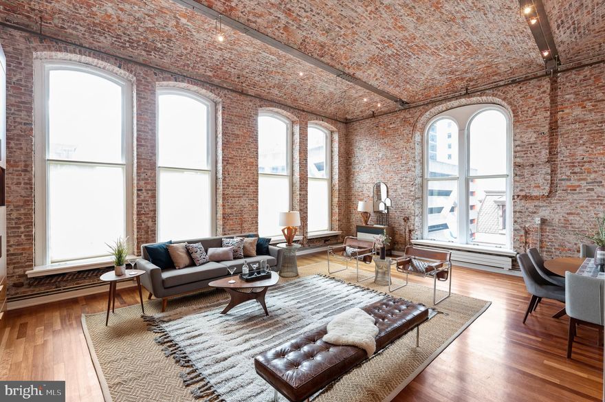 One of Philadelphia's premier condominium residences. This sun-filled, corner 3 bedroom plus family room plus office, 3 full bathroom home offers 15'+ vaulted, exposed brick ceilings; exposed brick walls; Fourteen 11.5' arched, double-hung windows on the south and west exposures; exposed beams and ductwork; and hardwood floors throughout. Stainless steel kitchen. Large And Modern tile baths. Excellent storage space. Solid core doors and fine quality finishes throughout. Pristine corner loft residence in the always desirable White Building. 2,700 square feet (+ 305 foot bonus loft space). Excellent storage. JUST AMAZING. The perfect combination of authentic, open loft space and delineated bedrooms. Midtown Village is already one of Philly’s best neighborhoods--not just ordinary places to walk to, but the City's very best restaurants, coffee shops, and retail. And the neighborhood is transforming into a very desirable, high-end residential village with so many new restaurants, coffee shops, shopping, high-end residential. All within 1-2 blocks. The White Building is a professionally managed, well run building with a bike room and a small fitness center. PARKING within half block. Pet Friendly! 100 WalkScore. McCall School Catchment. NOTE: The residence also includes a nice Bonus Loft Space. It has lower headroom, but provides an additional 305 sq/ft making the total square feet for the unit 3,005. The unit also includes a huge attic storage room, easily accessible with  pull down stairs. GARAGE PARKING--Seller will prepay one-year in neighborhood garage (within 2 blocks) with acceptable offer. Note—12 + Sansom, an architecturally beautiful building rising across the street has setbacks that will significantly improve the views from 304-305 from the previous building. The setback will allow for superb southern light as well (not to mention the awesome Western light). 12 + Sansom will offer ground level retail as well.