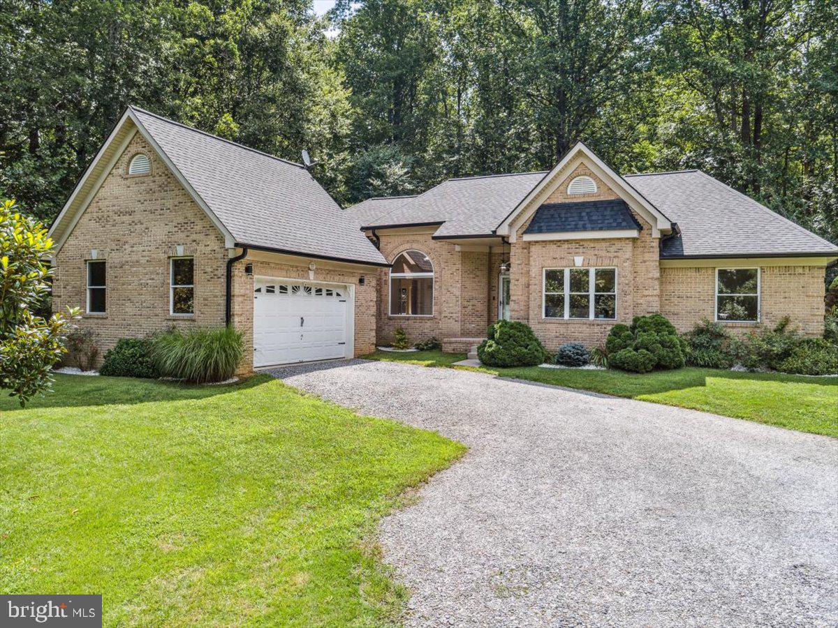 Privacy Meets Convenience on This Custom-Built 3-Acre Retreat – No HOA!
Nestled on a serene and secluded 3-acre lot, this one-of-a-kind all-brick rambler masterfully blends timeless elegance with nature’s tranquility—offering the perfect balance of peaceful seclusion and community connection. A rare find in today’s market, this home is a haven for those seeking both escape and engagement—all without the restrictions of an HOA.
From the moment you arrive, you’ll notice the custom architectural brick detailing and low-maintenance exterior that set the tone for the thoughtful design found throughout. Inside, soaring ceilings—ranging from 10 to 14 feet—flood the home with natural light, creating an airy, expansive atmosphere.
Highlights include:
• A stunning living room with cathedral ceiling
• Tray ceiling in the luxurious owner’s suite
• Vaulted hexagon ceiling in the sunlit breakfast area
• Raised ceilings in common areas and 9-ft ceilings in secondary bedrooms and bath
The heart of the home boasts a bright, open-concept kitchen complete with new stainless-steel appliances, abundant cabinetry, walk-in pantry, and a spacious eat-in breakfast area—perfect for everyday living or entertaining. Adjoining this space is a warm and welcoming family room that invites relaxation and connection.
Retreat to the owner’s suite, a private oasis featuring a spa-inspired bathroom with cathedral ceiling, separate walk-in shower, dual vanities, large walk-in closet, and private water closet. Additional bedrooms offer generous space, natural light, and distinctive architectural touches like a 3-row window bump-out with marble shelf.
Working from home? A spacious office with glass French doors provides both functionality and privacy.
Step outside to your personal backyard retreat, framed by mature landscaping, including a Magnolia tree, crepe myrtles, decorative marble-chip flower beds, and a lush Zoysia lawn. A vinyl privacy fence on the sides and chain-link at the back ensures both security and scenic views—plus, a small stream runs along the north side of the property for a natural touch of serenity.
Additional Features Include:
• No HOA
• New roof with transferable warranty (2023)
• Refinished hardwood floors, new carpeting throughout, and luxury vinyl tile in kitchen (2025)
• Fresh paint throughout (2025)
• Three storage sheds + 20-ft steel storage container
• Extensive LED lighting with dimmers throughout
• Lighting in all closets, kitchen counters, and showers
• Eight ceiling fans, including a remote-controlled fan in the living room
• Low-E/Argon gas-filled windows
• Multi-stage heat pump with heater package, UV germicidal light, and humidity control
• Wi-Fi thermostat with full reporting
• Pellet stove for added warmth
• 400-amp electrical service
• Verizon 5G UW high-speed internet
With its thoughtful design, modern updates, and unmatched setting, this home is a true sanctuary. Don’t miss your chance to experience a serene lifestyle in this unique and exceptional property—with no HOA to limit your freedom!
Be sure to check out the video walk through link for a better look!