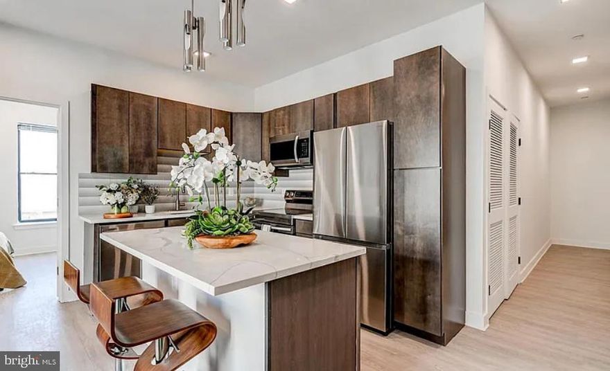 Discover your ideal apartment in The Brixton, where luxury living meets historic charm in the heart of Fells Point. Nestled in this picturesque neighborhood, our stunning apartments offer a refined living experience.

Built in 2023, these new apartments step into open floor plans with soaring ceilings, creating an airy, welcoming ambiance that's flooded with natural light. Your gourmet kitchen, adorned with sleek stainless-steel appliances and brushed nickel hardware, will inspire your inner chef. The custom walk-in closets, engineered hardwood flooring, quartz countertops, Philip Jeffries wallpaper, and posh lighting add more than a touch of opulence to your everyday routine.

Welcome to Fells Point, where charming cobblestone streets meet the waterfront. This pedestrian-friendly neighborhood boasts an array of bars, top-rated restaurants, and boutique stores. It's also home to one of Baltimore's most luxurious hotels, The Pendry. Explore historic streets, savor a lively culinary scene, and immerse yourself in the rich history and vibrant culture of this unique Baltimore neighborhood.

Your oasis at The Brixton awaits and we are ready to help you find your dream apartment!

Please note that the photos are of a model apartment home at The Brixton; however, the Matterport shows the actual apartment home.