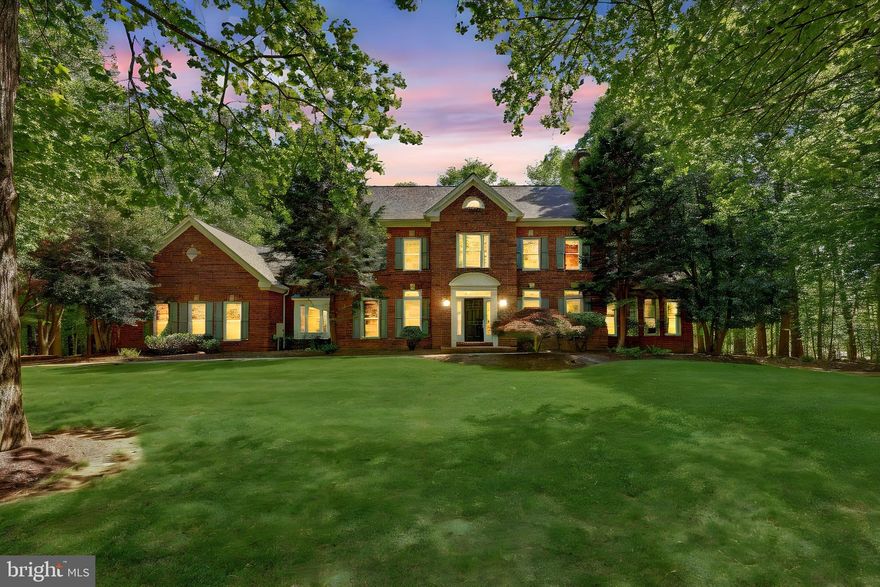 ***OPEN HOUSE CANCELLED FOR MAY 17TH***Tucked away on a picturesque five-acre lot, this stately brick colonial blends timeless architecture with luxurious living in one of Fairfax Station’s most serene and private settings. Located on a quiet, tree-lined road shared by just twelve homes in a self-managed HOA, this grand residence offers more than 6,000 square feet of beautifully appointed space across three finished levels. Surrounded by mature trees and natural beauty, the property offers the rare opportunity to own your own private oasis—with endless potential to create gardens, trails, a pool, or your dream outdoor retreat. Zoned for the highly sought-after Sangster Elementary and Lake Braddock Secondary School pyramid, the home welcomes you with a gracious marble-tiled foyer and gleaming hardwood floors that flow through the main living areas. A formal living room with a wood-burning fireplace sets the tone for warmth and sophistication, while an expansive, light-filled sunroom with cathedral ceilings and walls of windows invites you to relax or entertain in style. French doors lead out to a massive rear deck—resurfaced with TimberTech in 2024—stretching the full length of the home and offering sweeping views of your private, wooded sanctuary.

The main level continues with thoughtfully designed spaces including a formal dining room, a private home office, and a beautifully remodeled gourmet kitchen. Anchored by quartz countertops and white cabinetry, the kitchen is a chef’s dream with high-end stainless steel appliances, a beverage cooler, subway tile backsplash, under-cabinet lighting, a large walk-in pantry, a butler’s pantry, and a generous breakfast area. It opens into a dramatic two-story family room, featuring a cozy wood-burning fireplace and drenched in natural light from windows on every wall. Dual sliding glass doors provide seamless access to the deck, enhancing the home’s indoor-outdoor flow. Just off the kitchen, a practical mudroom connects directly to a spacious three-car garage, offering everyday convenience without compromising on elegance.

Upstairs, the home features four sizable bedrooms with soft carpeting, including a luxurious primary suite with vaulted ceilings, a cozy sitting area, and a spa-inspired en-suite bath. Enjoy a freestanding soaking tub, double quartz vanity, oversized glass shower, skylight, and a large walk-in closet. One secondary bedroom includes its own private en-suite bath, while the remaining bedrooms share an updated hall bath with new tile finishes. The finished lower level offers incredible flexibility with newer carpet throughout, a spacious recreation area with a third wood-burning fireplace, a bonus room ideal for a guest suite or fifth bedroom, a full bathroom, and two large unfinished storage rooms with potential for future customization.
Additional highlights include a new sunroom HVAC system (2025), Andersen window replacements (2022) throughout much of the home, and architectural roof shingles (approx. six years old). Ideally located just minutes from Rt. 123, Burke Lake Park, Burke Centre, Fairfax County Parkway, and I-95, this exceptional property delivers privacy, space, and elegance—all in a prime Fairfax Station location. With so much land, the possibilities are truly endless. Whether you're dreaming of outdoor adventures, hosting unforgettable gatherings, or simply enjoying the peace of nature, this is a place to create lasting memories.