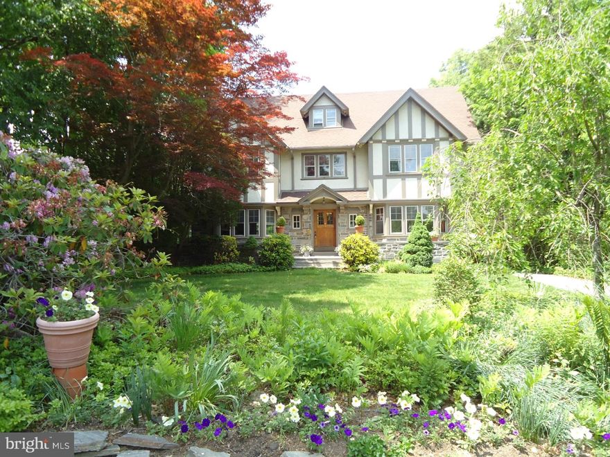 Set in a professionally landscaped garden, this beautiful Tudor home can easily entertain a party for 100 or an intimate family dinner.  This is a stunning home with many original details?wainscoting, bay window seats, beamed ceiling, original stained glass, detailed tiles?and the modern comforts we have come to expect?central air conditioning, new kitchen, new master bathroom, guest accommodations.  The back garden is very private and extends past the detached garage.  The location is also unparalleled.  Linwood Park is just a house away with its play equipment and frequent community events.  With a Walk Score of 82, you are moments from the Ardmore train station, Suburban Square, Trader Joe and Whole Foods and can use the sidewalks to get there!  Schools are close by (a choice of high schools) and the commute to Center City and the airport are short.  The elegant foyer with its stained glass windows, carved turned stair and 4 foot wainscoting sets the standard for the rest of this 1910 home. The Living Room features a coffered ceiling and stone fireplace and the adjacent Sunroom has lovely Chippendale transoms over its windows.  The Dining Room has an extended bay window with window seats and there is a built-in china closet.  The remainder of your dining service and glassware can be stored in the adjoining Butler's Pantry.  The sunny new eat-in Kitchen has cream wooden cabinets with granite counters and state-of-the-art stainless steel appliances.  Just off the kitchen is the Laundry Room and Mud Room.  The Master Bedroom has a walk-in closet and new marble bathroom.  The remainder of the second floor has three bedrooms and a full bathroom.  The third floor has a Playroom with built-in cabinet and sink which is great for cleaning up after arts and crafts.  There is a spacious Family Room for relaxing, playing music, etc.  A 5th Bedroom and a full Bathroom on this level make a nice get away for your overnight guests.  From the instant you walk in, you will know this home was meant to be yours.