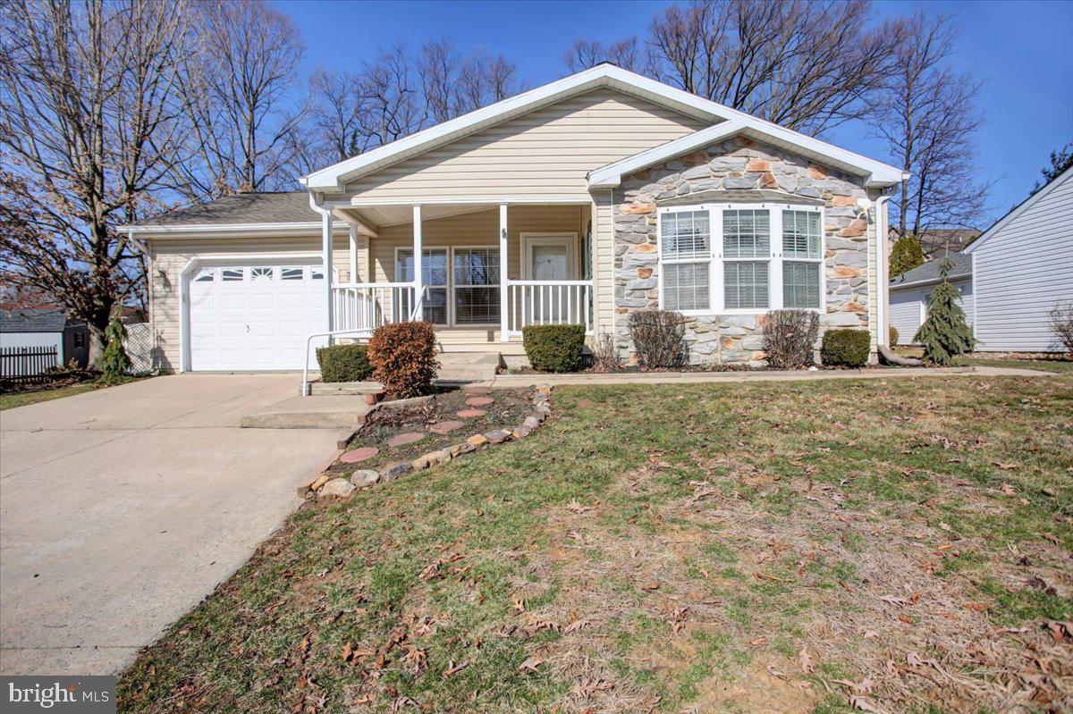 DISCOVER THE PERFECT 55+ LIVING in this beautifully updated ranch home within a gated community. Boasting 2 bedrooms, 2 full baths, and a den, this residence offers new carpet and fresh paint throughout. The open concept living and dining rooms create an inviting atmosphere, enhanced by a cozy gas fireplace. The large, bright kitchen features a pantry and breakfast nook, ideal for culinary enthusiasts. Retreat to the main suite, complete with ample space for king-sized furniture, two closets, and a private bathroom with a walk-in shower. A 1-car garage provides convenient parking and storage. The home is economically heated with natural gas forced hot air and cooled with central A/C. The community offers a tastefully appointed club house featuring a large room for personal or community gatherings, full kitchen with island, cozy gas fireplace, community run activities and library, and for an extra fee, fitness room access. Other community amenities include security gates at all entrances, a dock with a screened-in gazebo overlooking the mountain and stocked fishpond with fountain, yard games and walking trails. This exclusive, quiet lifestyle comes with your full ownership of the home as deeded airspace rights and a 29-year, renewable, land lease for your lot with a monthly fee of $633, which also includes your sewer, trash and recycling. Pets are welcome and limited to two per household. Conveniently located to lots of shopping, restaurants, entertainment, golf, doctors and hospitals and major highways. Embrace the ease and comfort of this well-appointed home, designed for a carefree lifestyle.