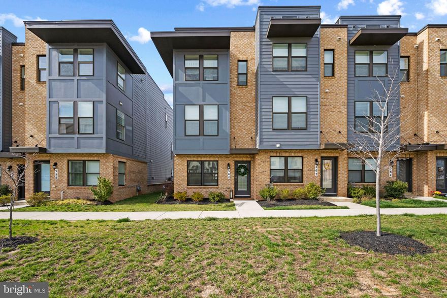 Modern Carlton model end-of-group townhouse residence built in 2022 by D.R. Horton, offering 4 bedrooms, 4 full bathrooms, 1,793 finished square feet, and a 1-car garage, ideally positioned in a prime, high-elevation setting within Frederick’s most sought-after community, Renn Quarter. Designed for both comfortable everyday living and effortless entertaining, the Carlton model features a bright, airy interior filled with natural light throughout. The entry level welcomes you with a foyer featuring built-in storage, leading to a hallway with garage access and a private bedroom with dual access to a full bathroom—perfect for guests or a home office. Upstairs, the open-concept main level is finished with LVT flooring and showcases a spacious, sunlit living room with access to a private balcony. The adjoining eat-in kitchen is beautifully appointed with upgraded countertops, stainless steel appliances, a peninsula with breakfast bar seating, white shaker-style cabinetry with sleek bar pulls, and pendant lighting. A bedroom and full bathroom on this level add flexibility for a variety of living arrangements. The upper level features two carpeted bedrooms and two full bathrooms, including a well-designed primary suite with a wall of custom built-in shelving, storage, and a desk area, along with an attached ensuite bath featuring a dual-sink vanity and a walk-in closet. The secondary bedroom offers dual access to an additional full bathroom, and a conveniently located laundry closet completes this level. Residents enjoy access to community amenities, including a fitness center and a pool with a children’s area, as well as the newly approved 78-acre FCPC park and Carroll Creek Park walkway extension. Just moments from award-winning downtown Frederick, this location offers a vibrant mix of historic charm, local dining, and boutique shopping, along with scenic Appalachian Mountain views, nearby access to the Monocacy River and Carroll Creek, and convenient commuter routes including I-70, I-270, Route 40, Route 144, and Route 15.