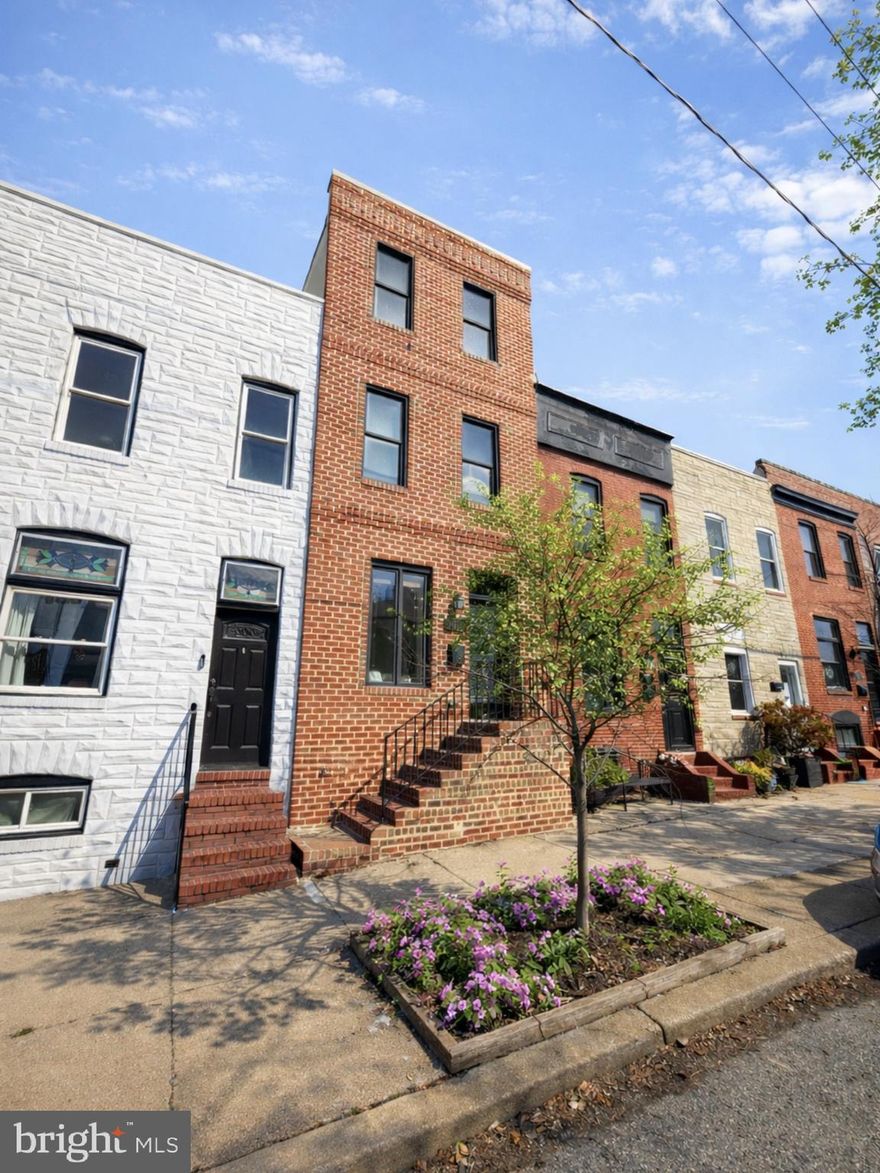 Amazing opportunity to own a four-story brick rowhome in the heart of Canton, offering unobstructed 360-degree views of the water, the iconic Baltimore skyline, and Patterson Park! This turn-key residence is ready for immediate occupancy and showcases a versatile floor plan ideal for roommates, guests or work-from-home. The main level welcomes you with wood floors, a striking exposed brick wall, and impressive 9-foot ceilings that create a warm yet open feel. A spacious living room flows seamlessly into the well-appointed kitchen, featuring rich wood cabinetry, granite countertops, stainless steel appliances, and a convenient breakfast bar—perfect for everyday living and entertaining. The main level half bath and a large closet are a must for modern convenience. The mid-level offers two generously sized bedrooms with brand-new carpet and ceiling fans, along with a shared hall bath complete with a soaking tub and separate shower. The third floor features a primary suite, boasting  brand new carpet, ample closet space and a luxurious en-suite bath with a soaking tub and separate shower. Entertaining is effortless with the third-floor party room featuring a bar and direct access to the expansive rooftop deck—where panoramic views of the water, skyline, and park provide an unforgettable backdrop. The finished lower level, with excellent ceiling height and brand new carpet, offers additional living space ideal for a recreation room, home gym, or media area. A full bathroom and dedicated laundry area add convenience and functionality to this exceptional home. Peace of mind comes with a one year home warranty of the buyer's choice. Don’t miss this rare opportunity to enjoy city living, incredible views, and flexible space—all in one remarkable property.